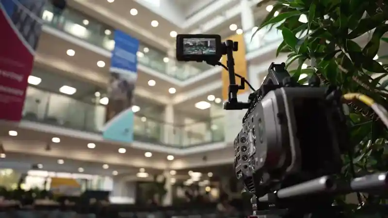 Professional camera and streaming setup capturing live sessions inside the L&G Retail Tech Summit atrium.