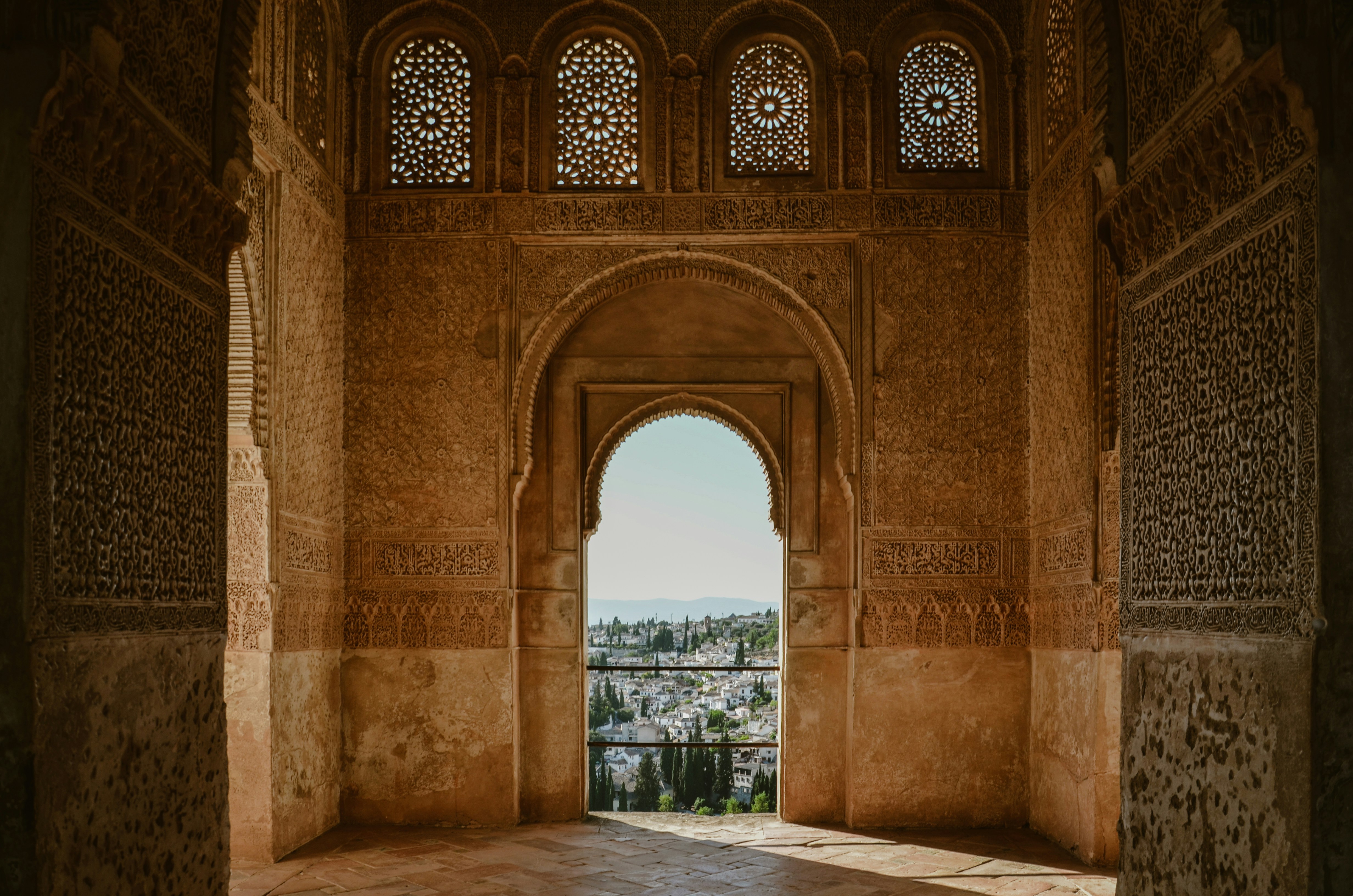 an archway in a building with a view of a city