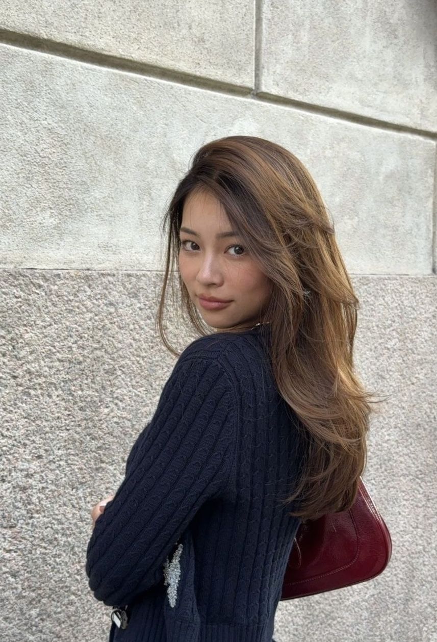 woman in black long sleeve shirt sitting on white couch