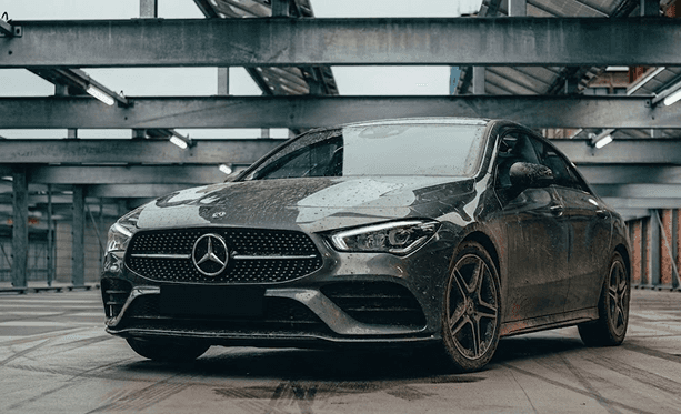 a car parked in a parking lot with graffiti on it