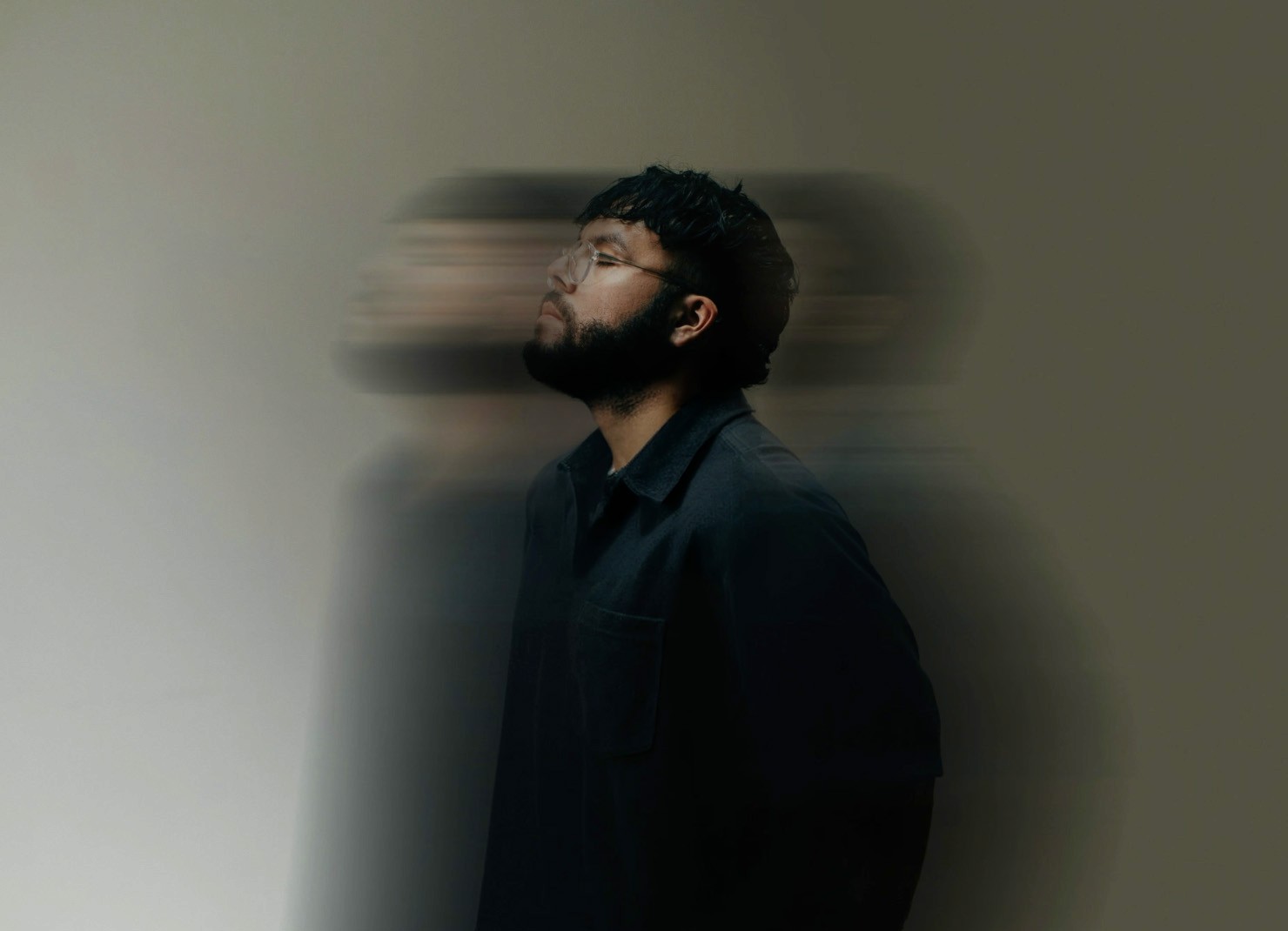a slightly motion blurred image of a man looking up stylised photography