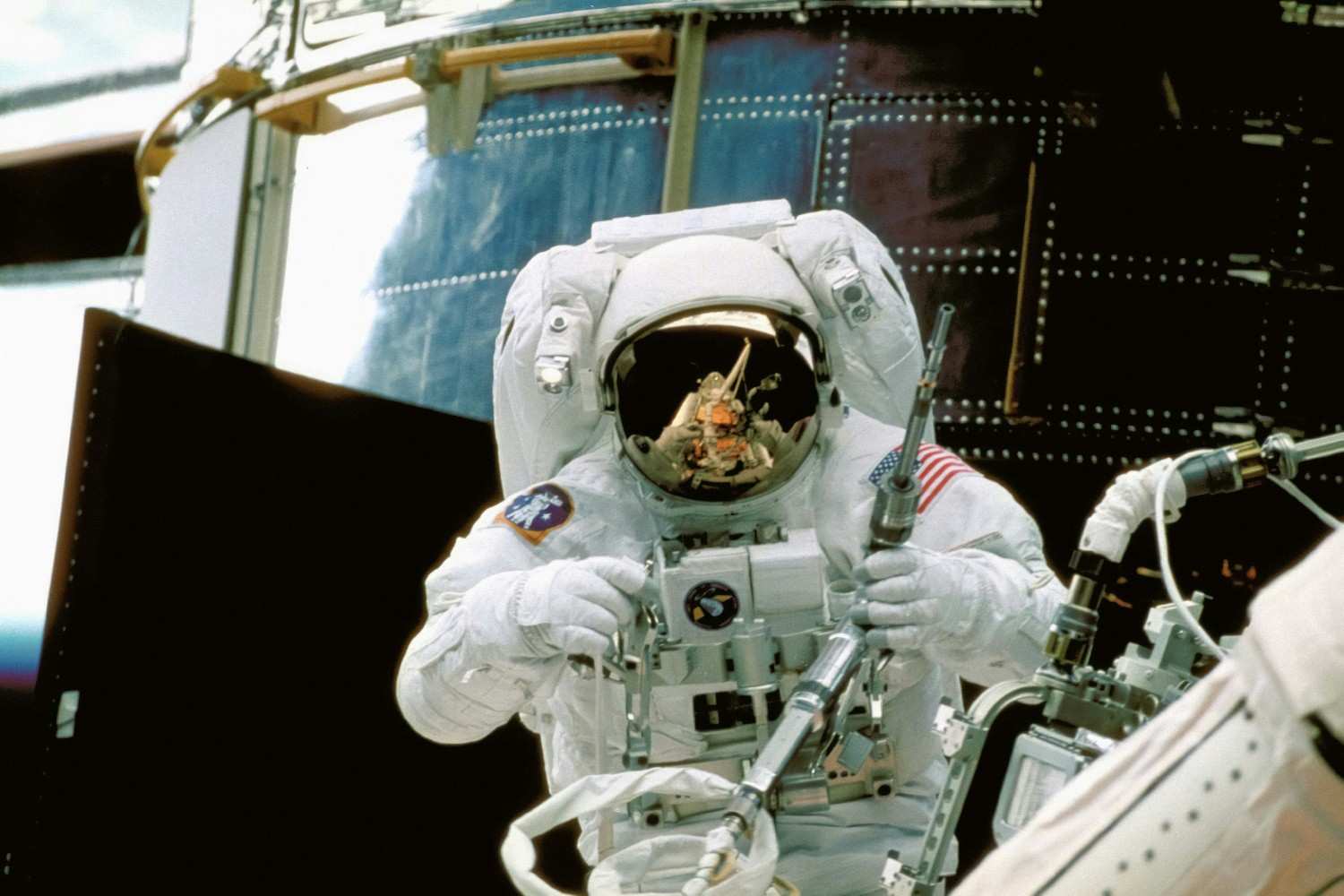 Astronaut working outside a spacecraft during a spacewalk