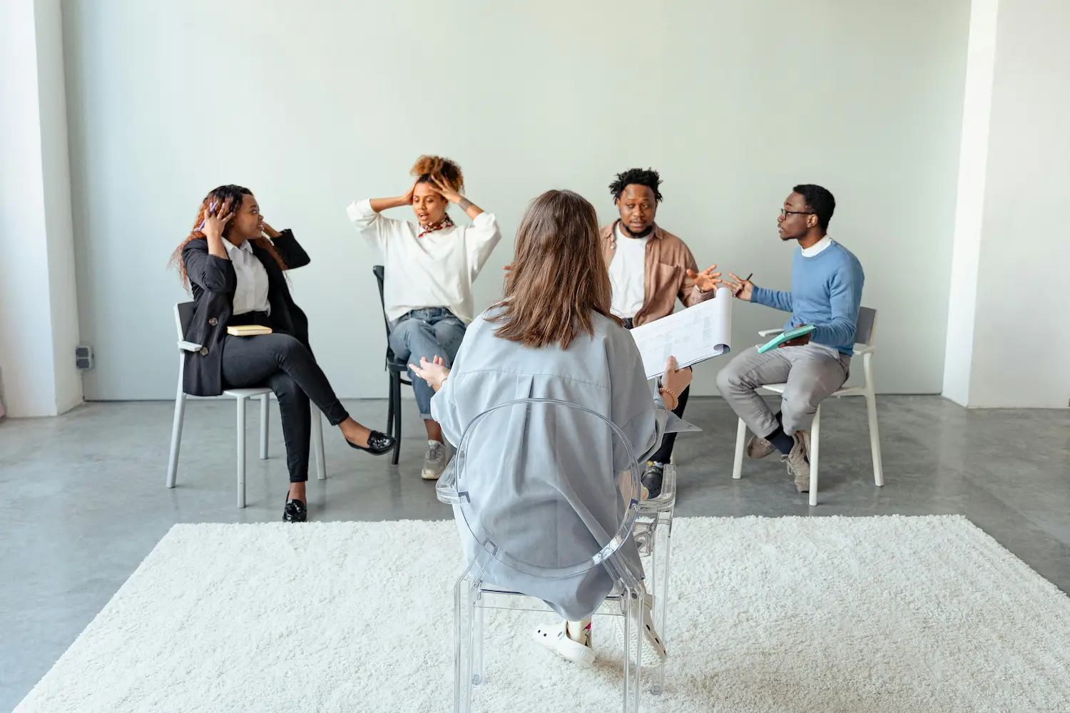 Diverse group therapy session in NYC with participants sharing experiences during counseling, highlighting in-person and CBT/DBT group therapy support