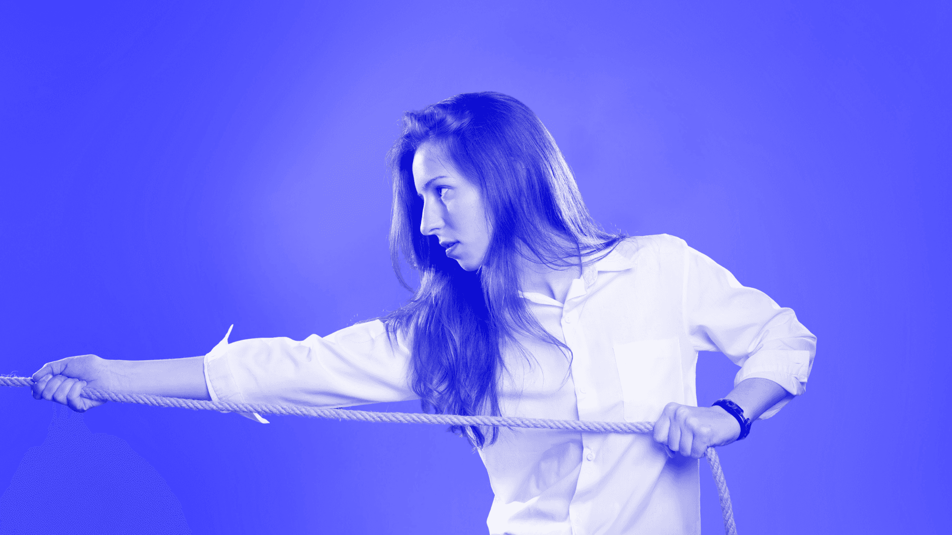 A woman in a shirt pulling on a rope