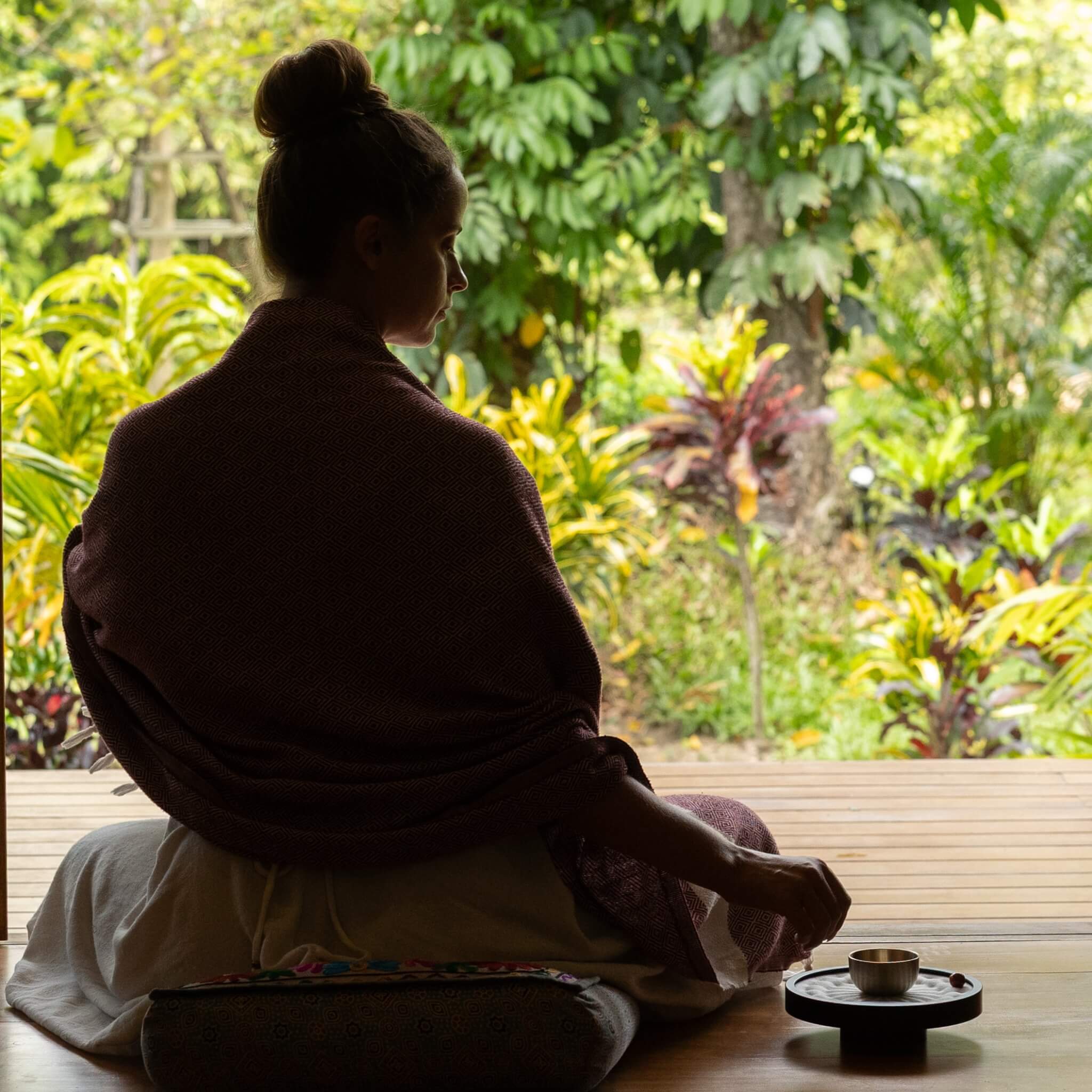 Woman meditating with white TAOO timer