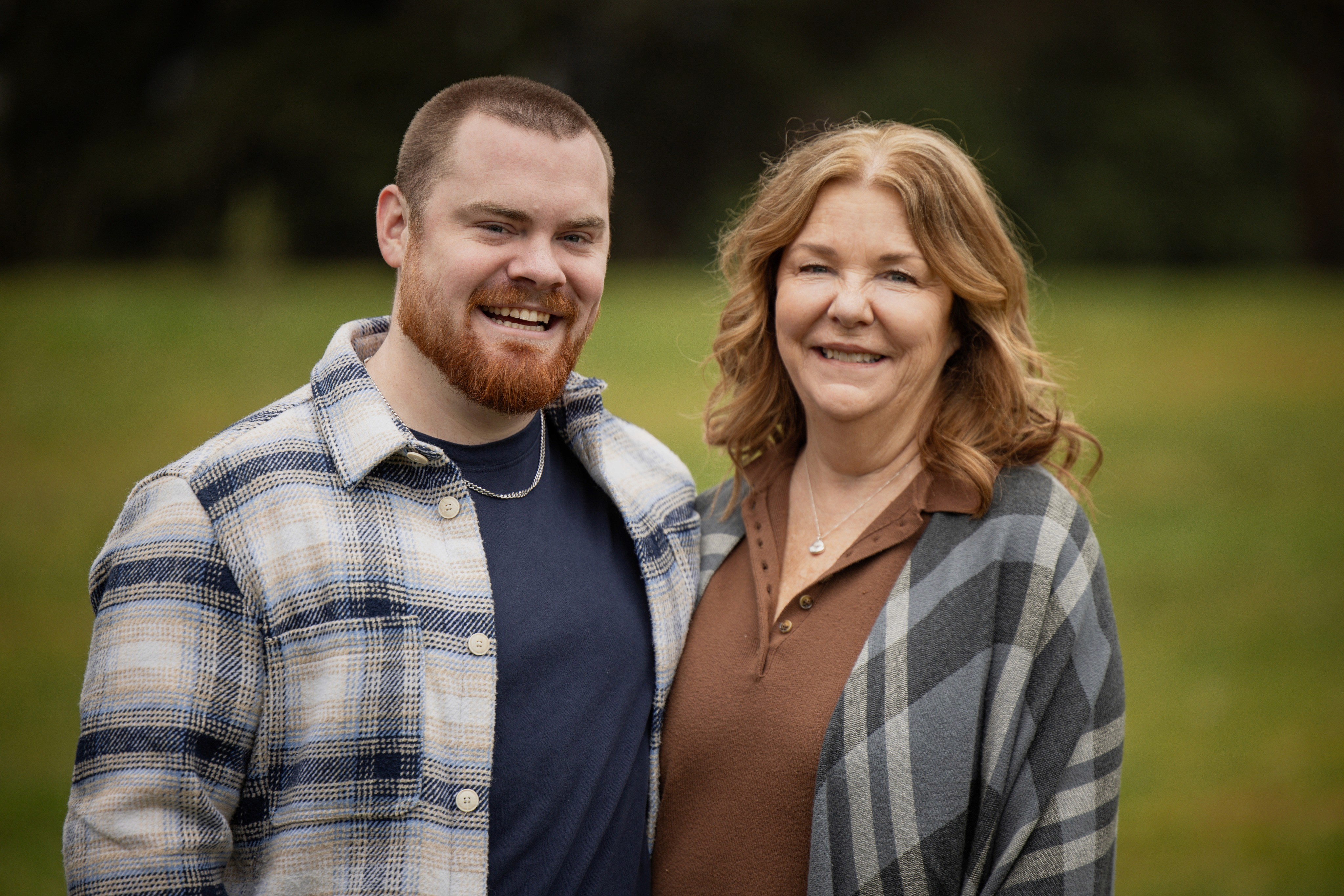 Red-bearded son and his mother smiling side by side
