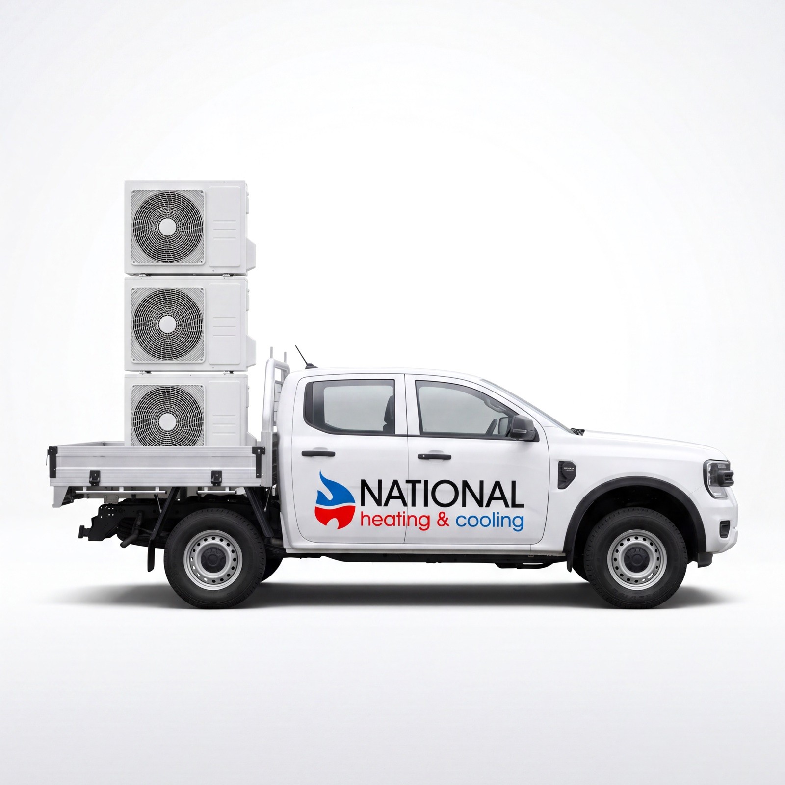 National Heating & Cooling ute with door signage, carrying three outdoor units