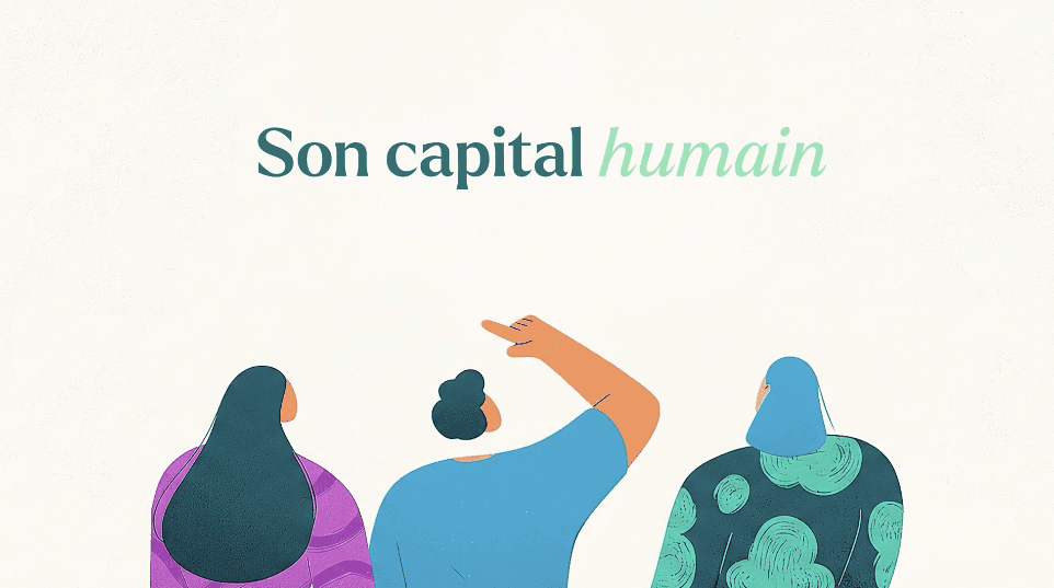 Two people lie in the snow making snow angels, one in a dark jacket, the other in red. Footprints lead to them. The scene feels joyful and playful.