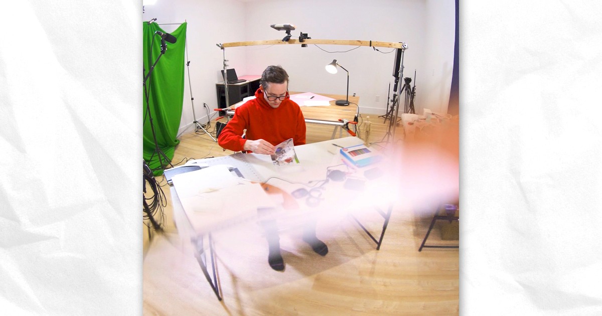 A man in a film studio flipping paper pages