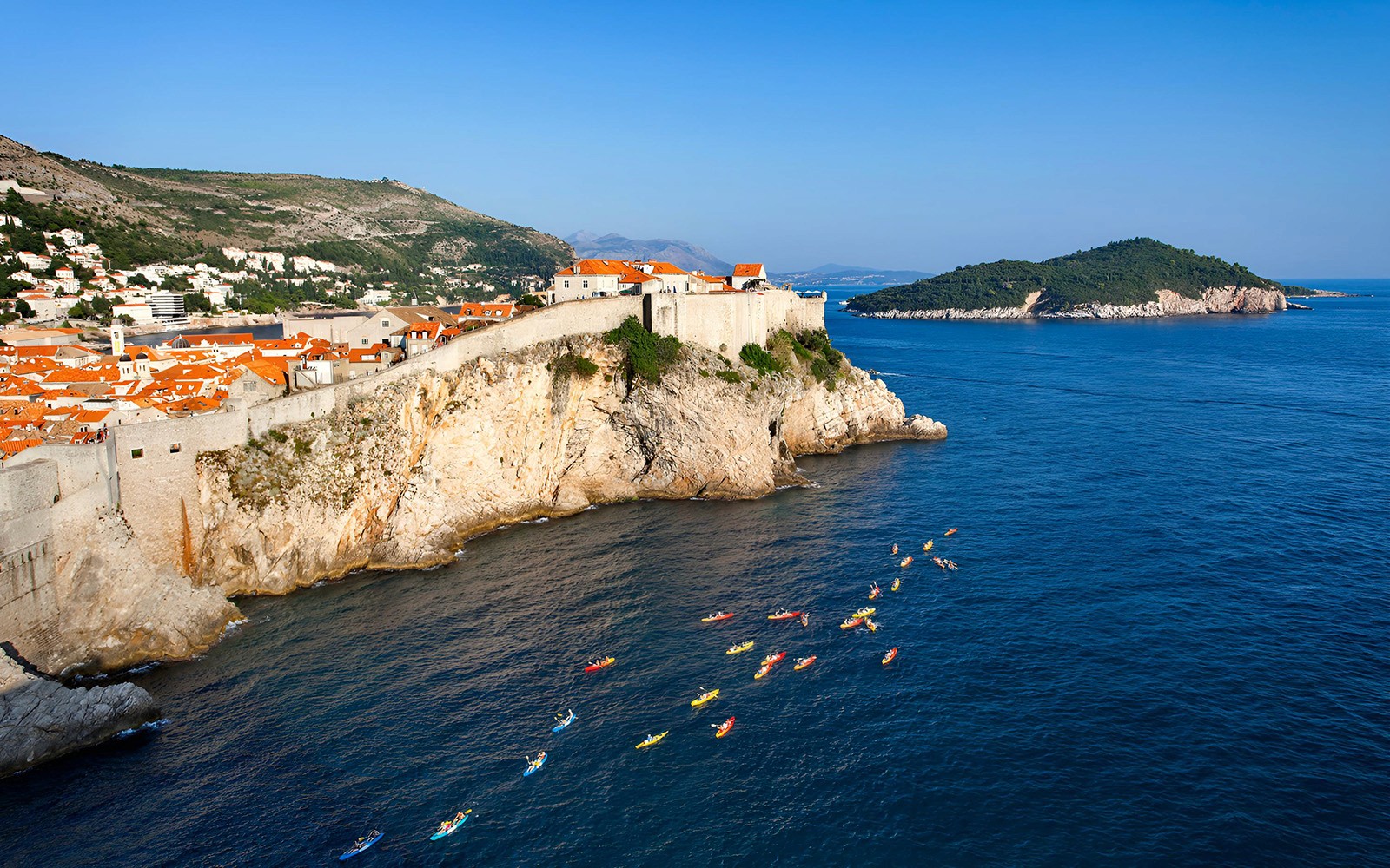 Kayakers near Old Town Walls on a coastal tour.