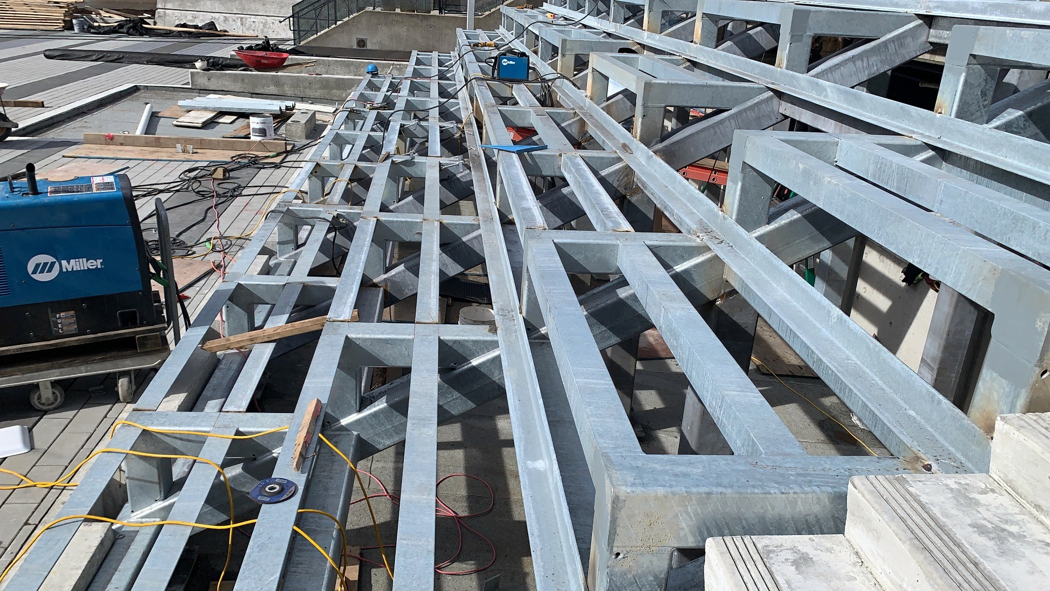 Rows of galvanized tiered steel seating-platform framing