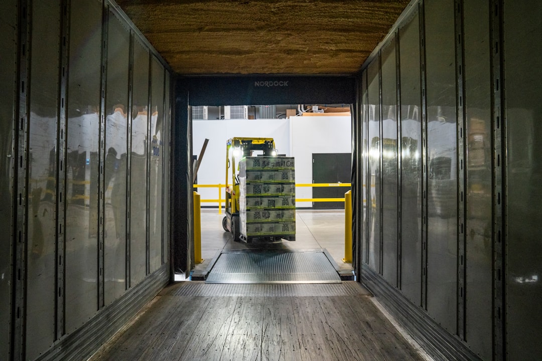 Yellow and black forklift transporting goods in a logistics warehouse, symbolizing outsoucre logistics operations.