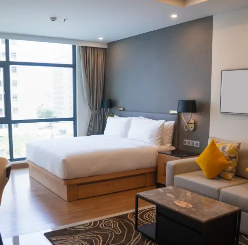 white bed linen with throw pillows