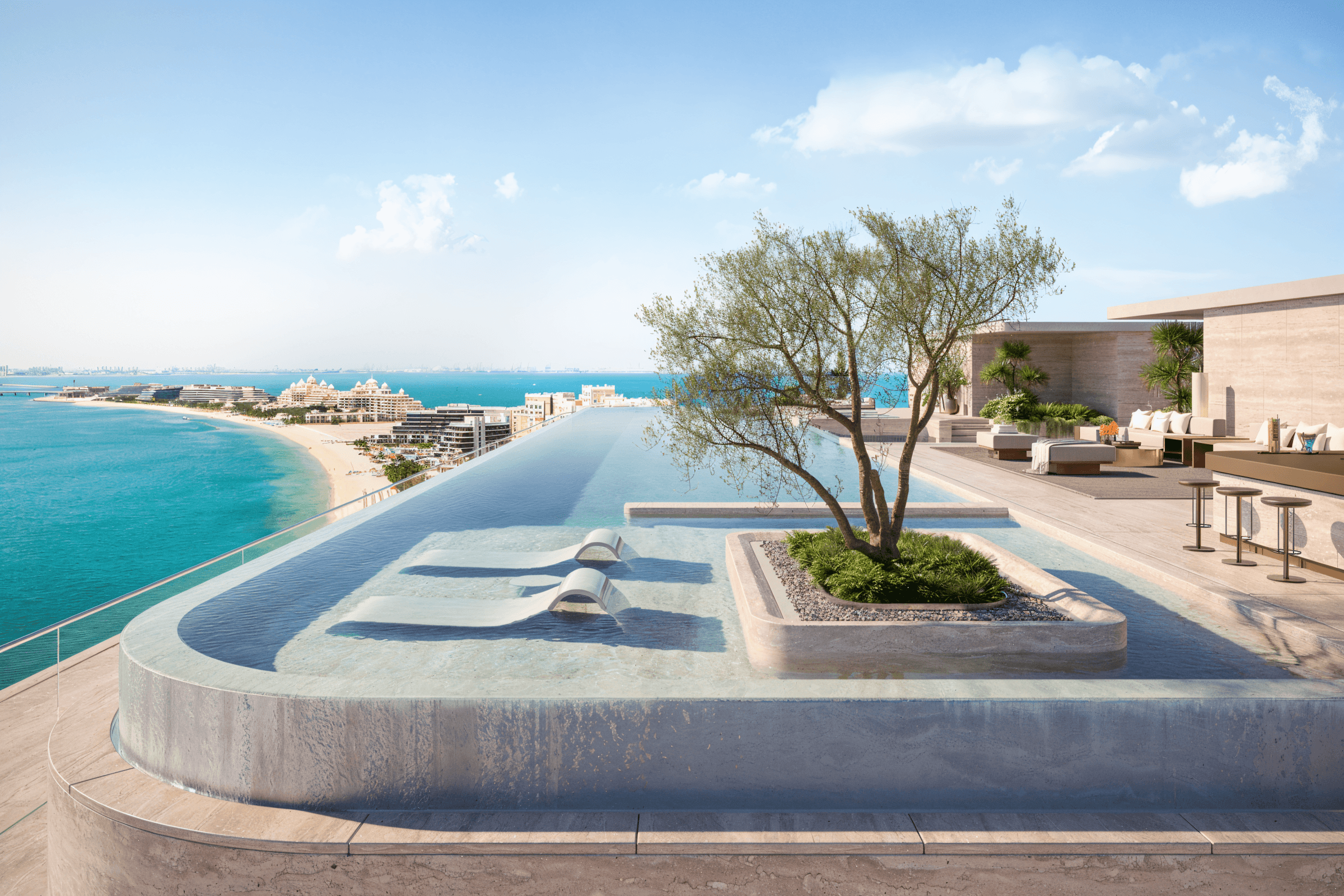 A tranquil pool at the beachfront villa is surrounded by vibrant trees, highlighting the beauty of Omniyat Bespoke.