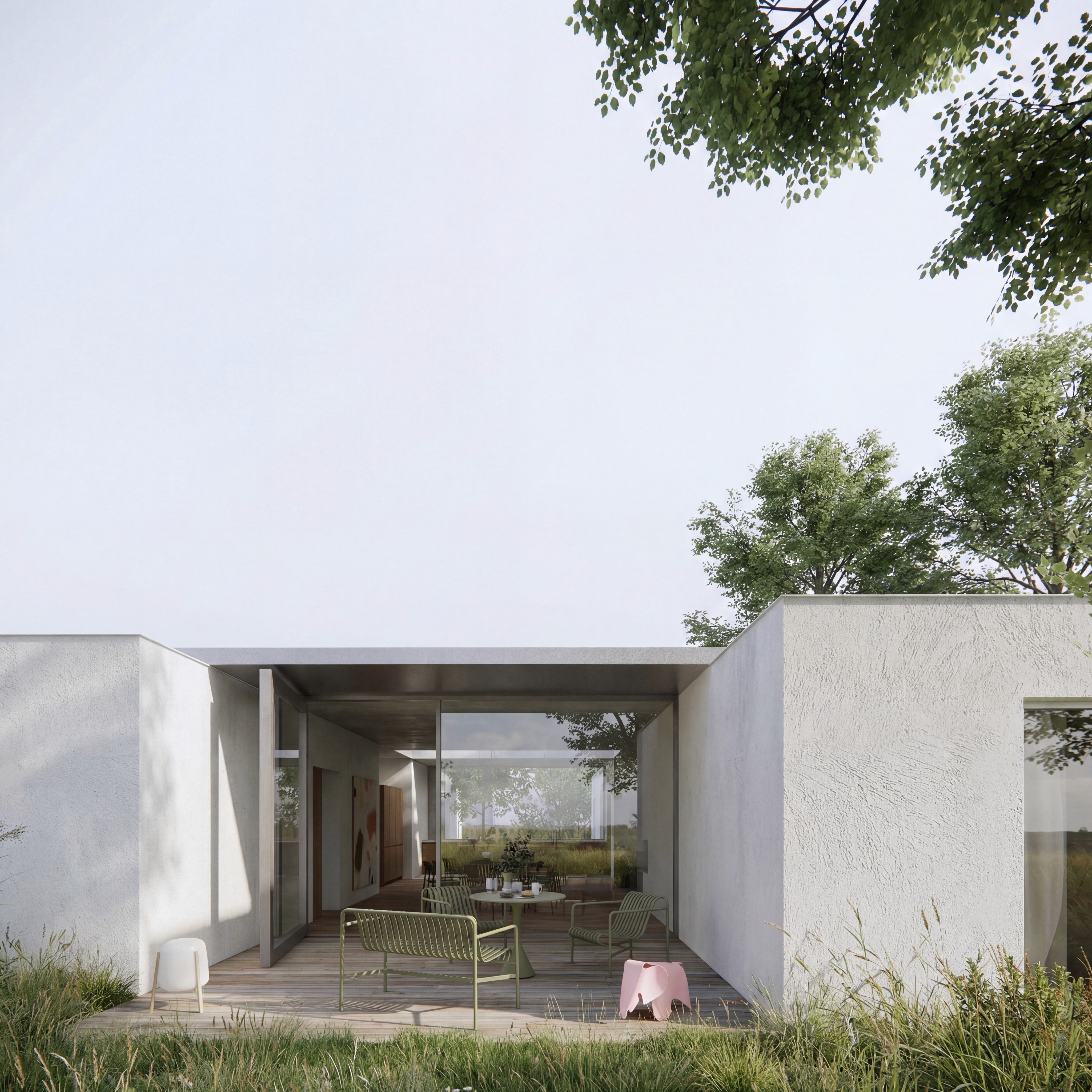 Modern architectural structure with a minimalist exterior, featuring an open space and surrounding greenery.