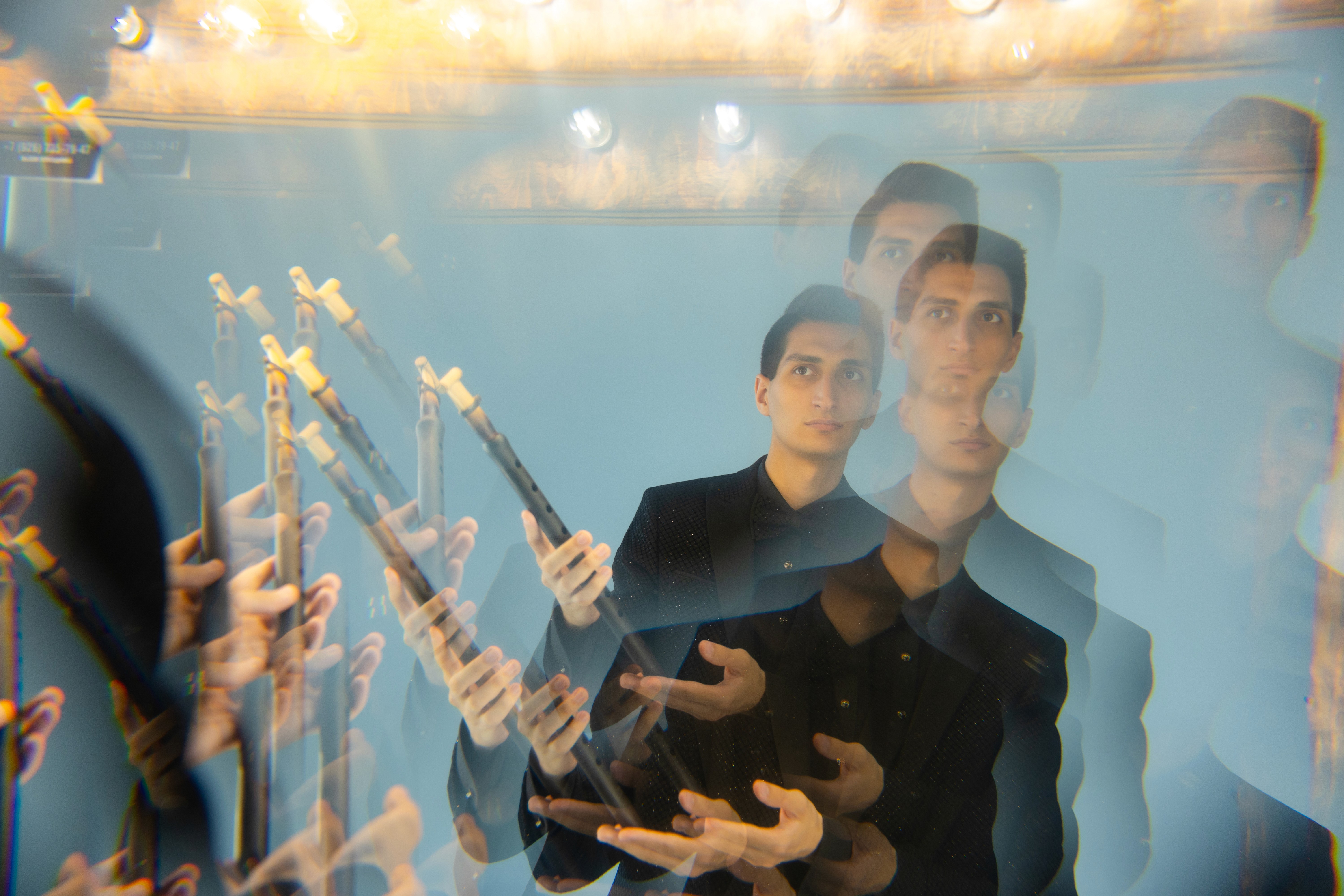    Erik Mirzoyan holding a duduk in a layered multiple-exposure portrait