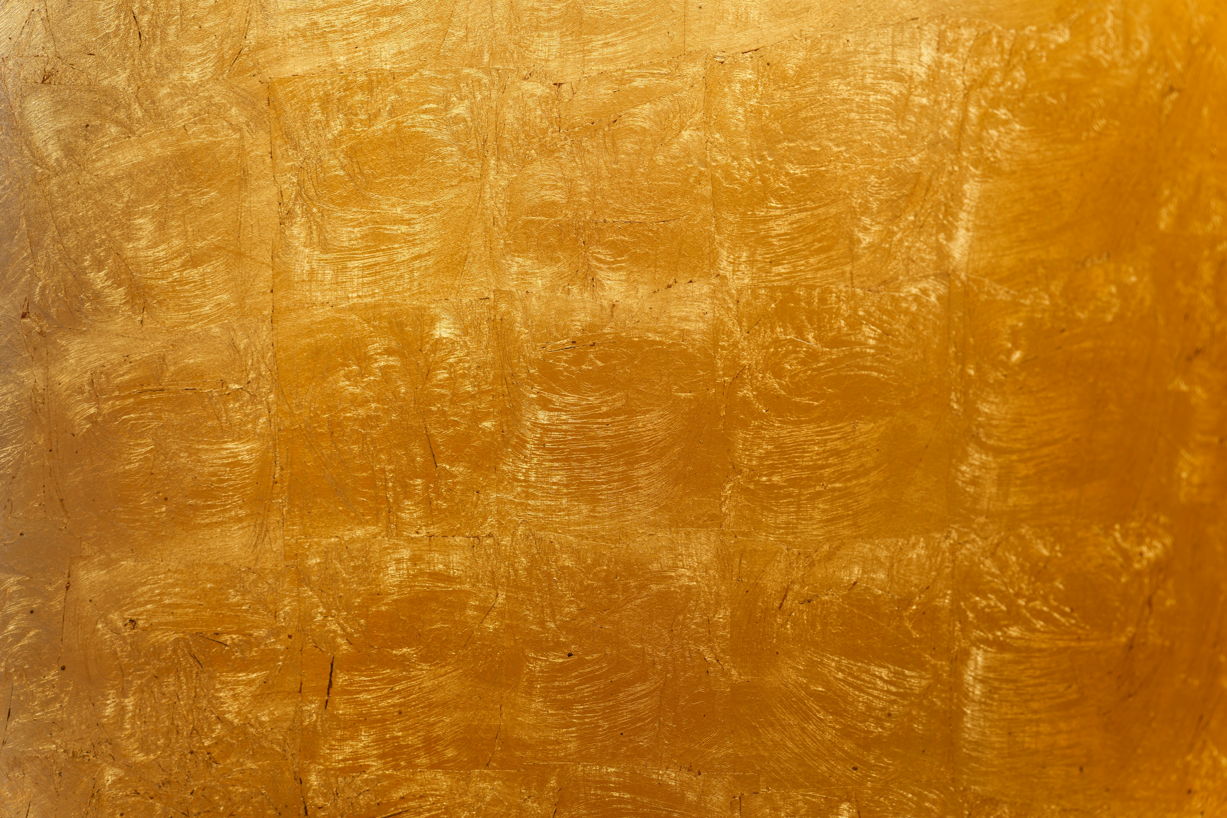 Abstract golden textured background with shimmering light.