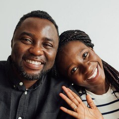 Smiling couple, woman waves at camera