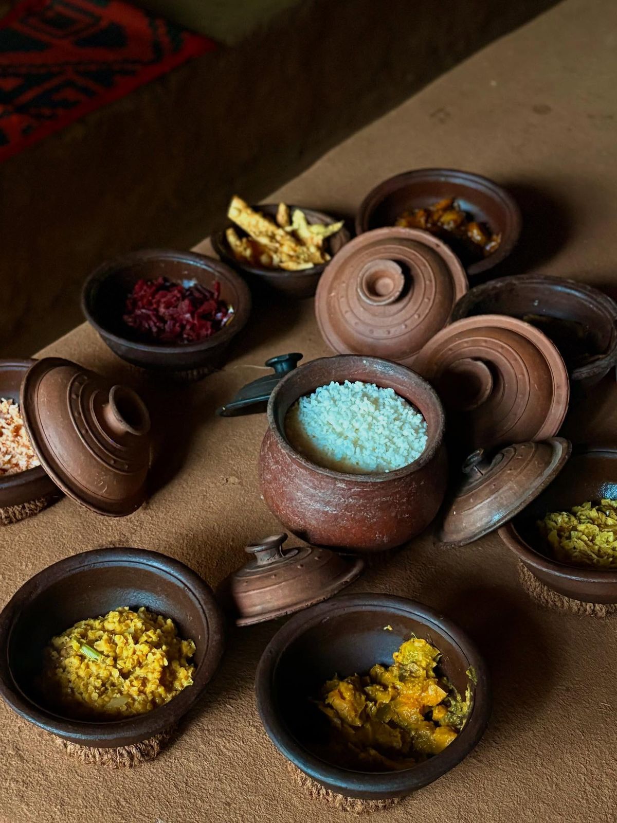 A man playing a drum in front of a group of people