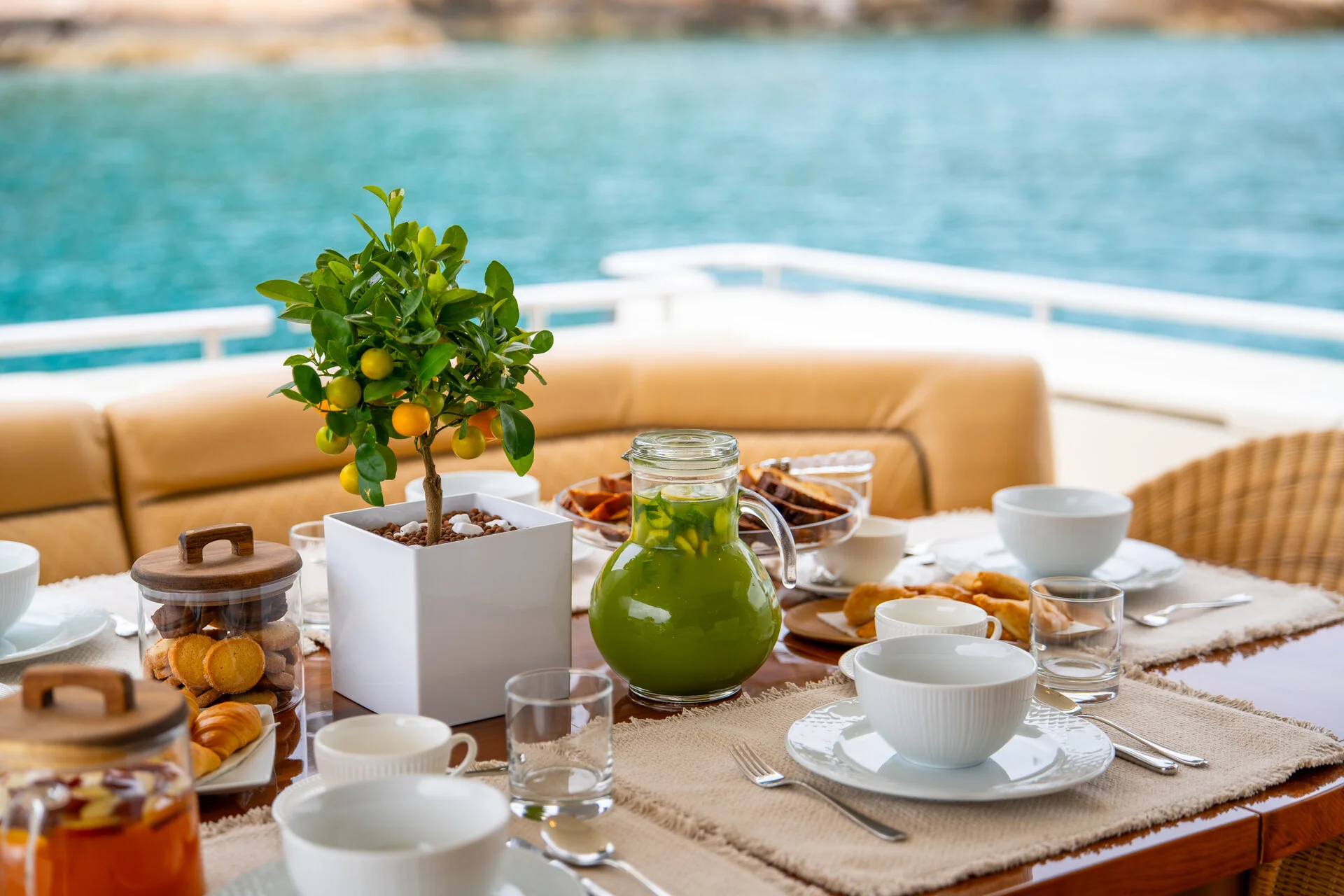 White Rock 36 speedboat with captain at helm cruising calm blue waters near Paros coastline with hills in background.