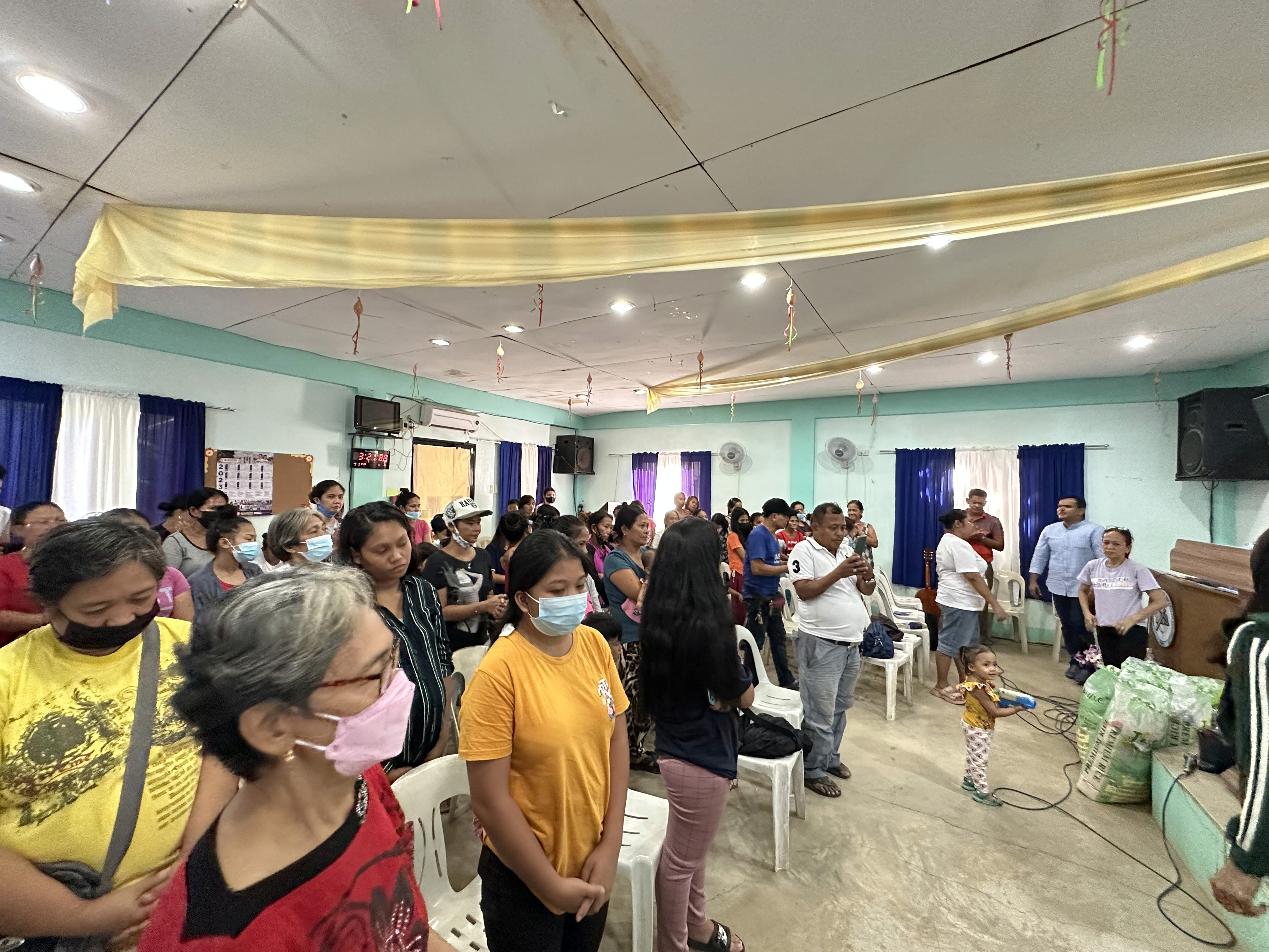 A crowd of people facing away from the camera.