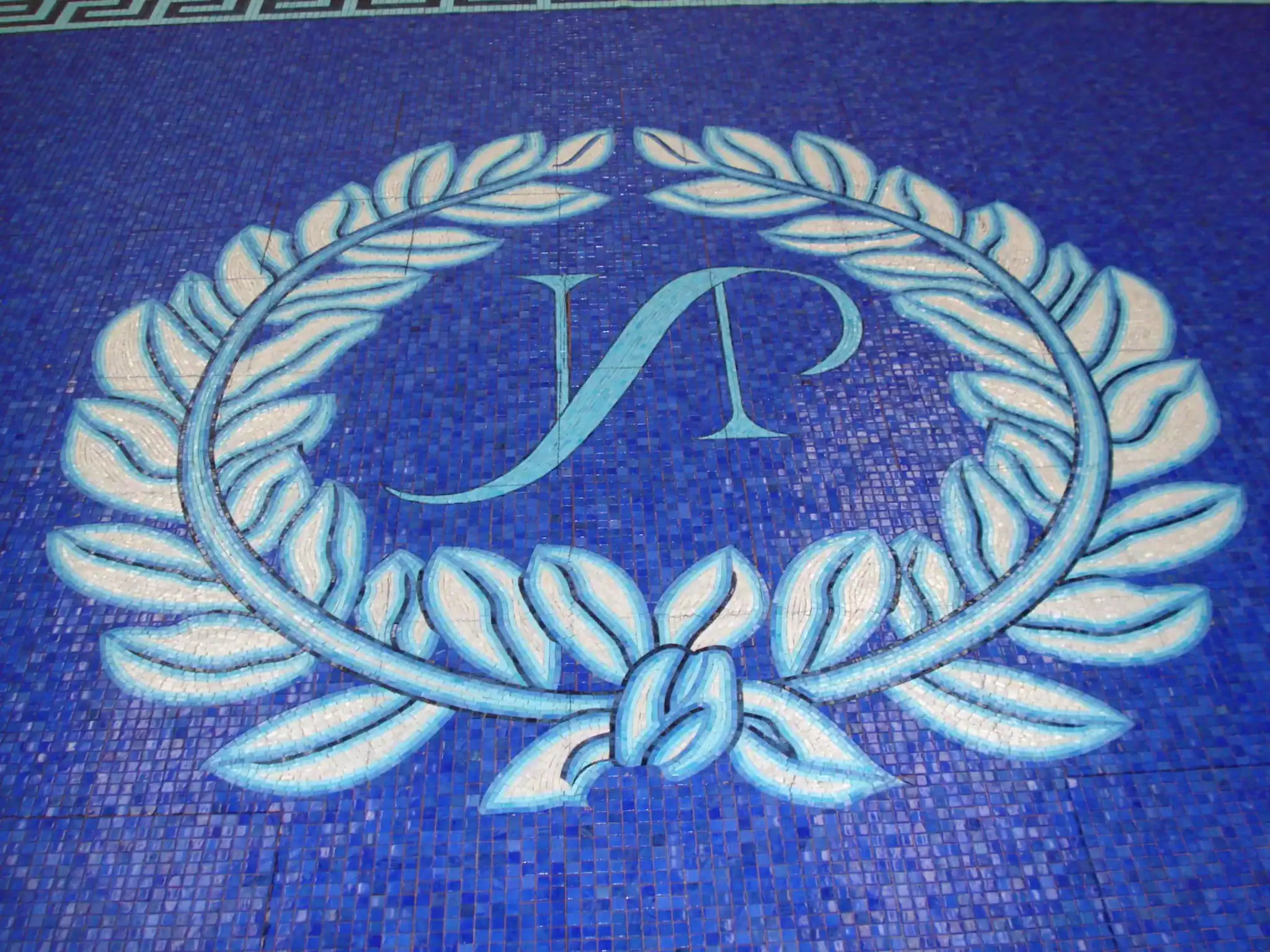 Greek style pool mosaic with a decorative key border and Roman-inspired motifs. Perfect for enhancin.