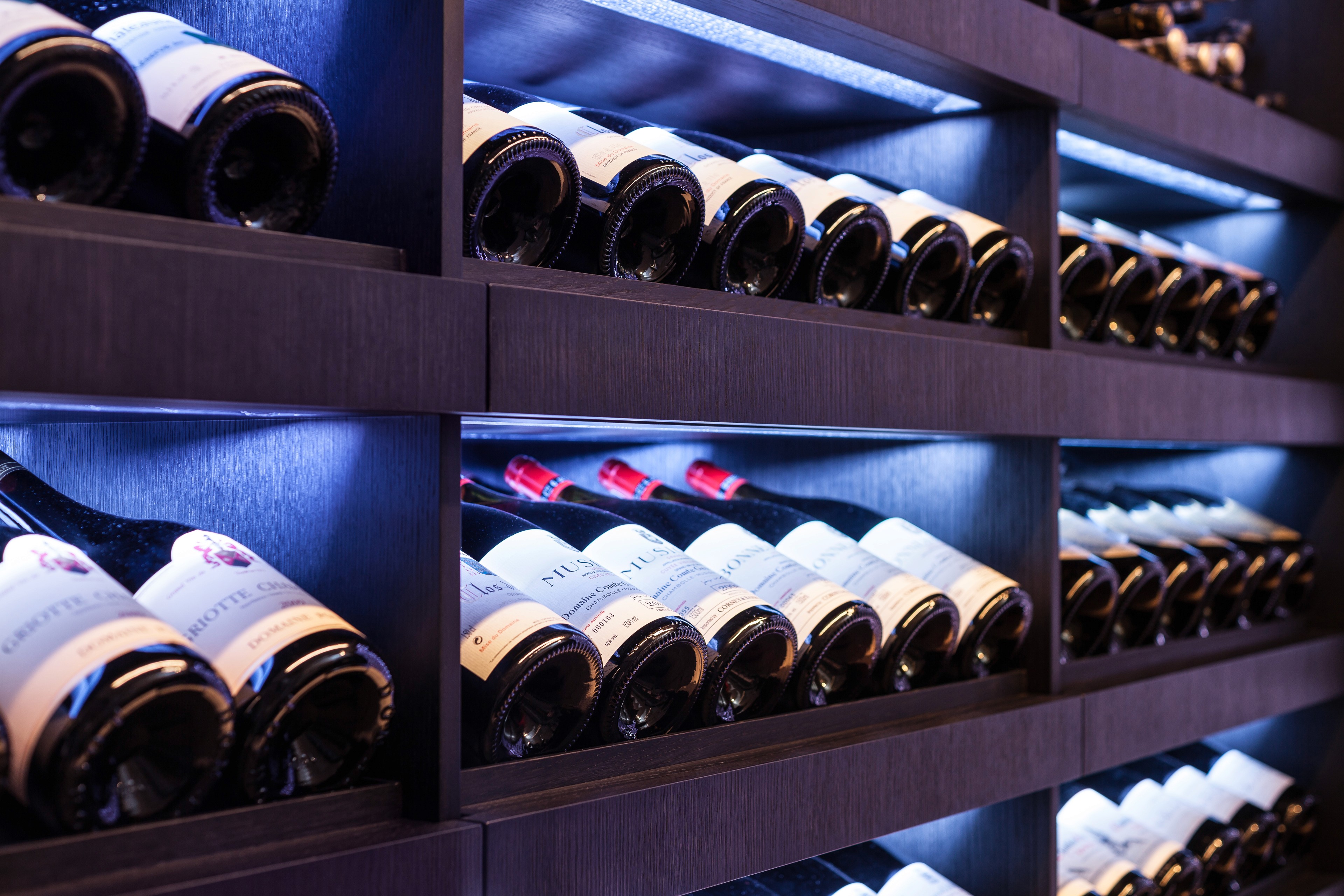 angled Closeup of bottles stored on bespoke shelving, North London