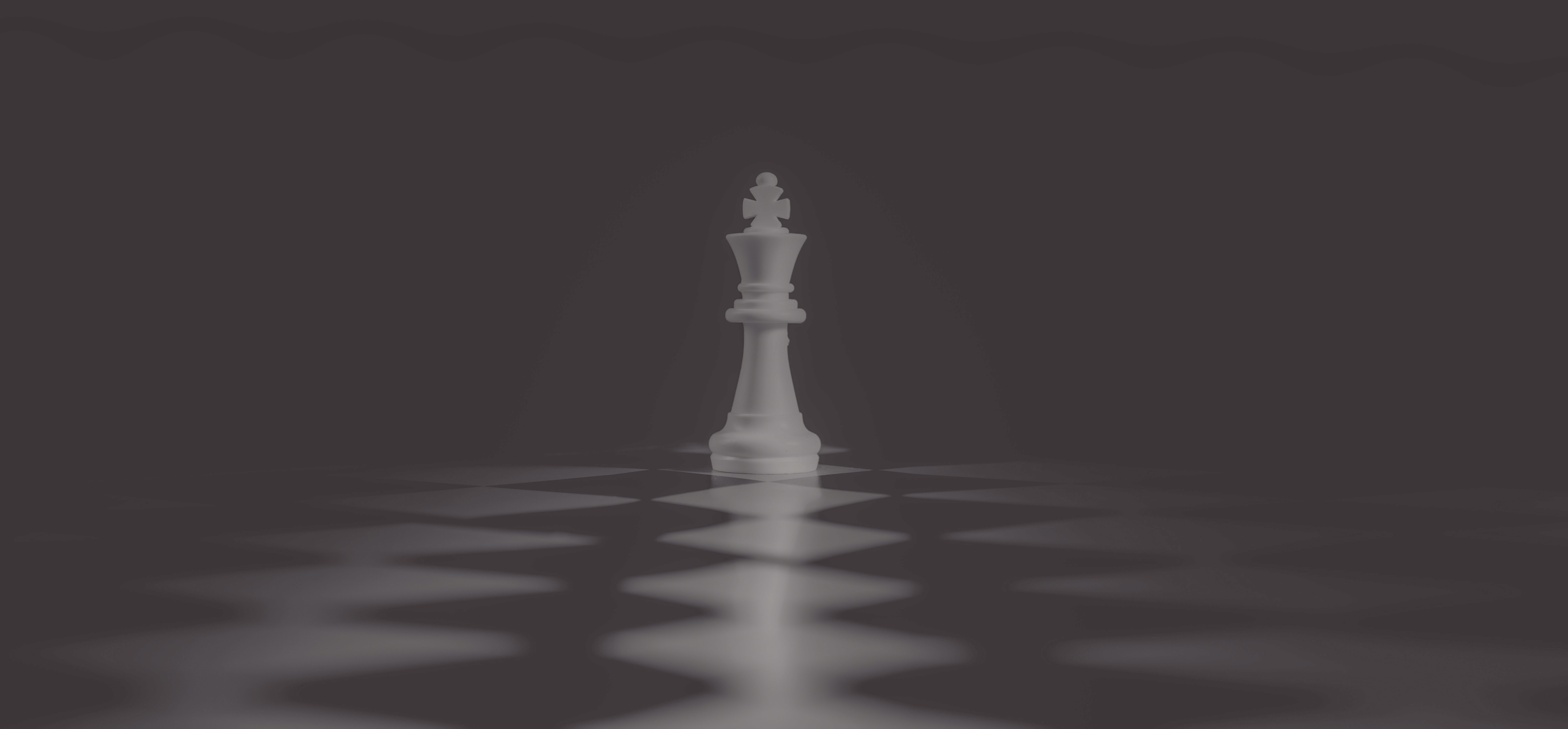 White chess king piece on a chessboard