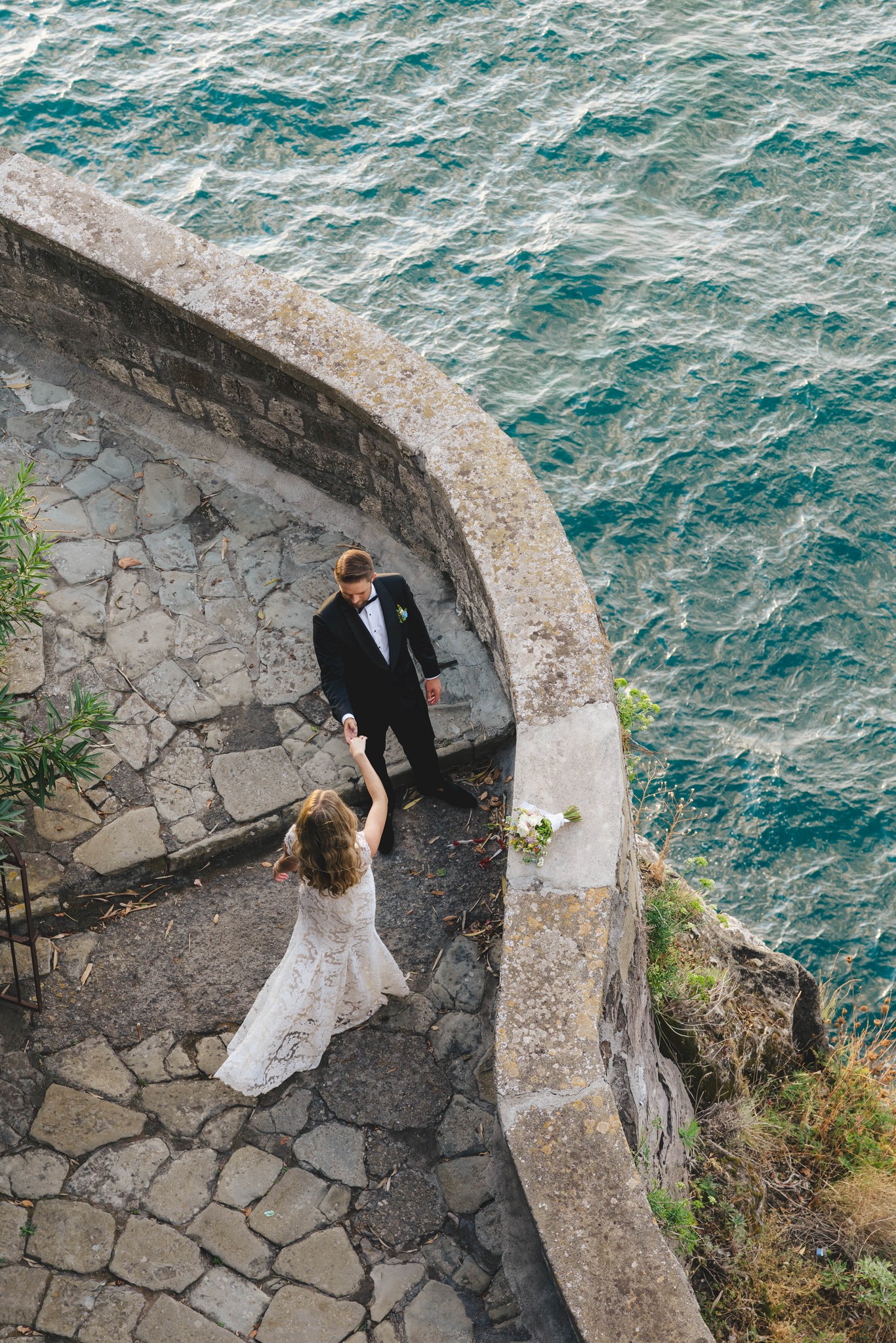     Palm Beach wedding photographer captures a bride and groom overlooking the coastline during a destination wedding portrait.