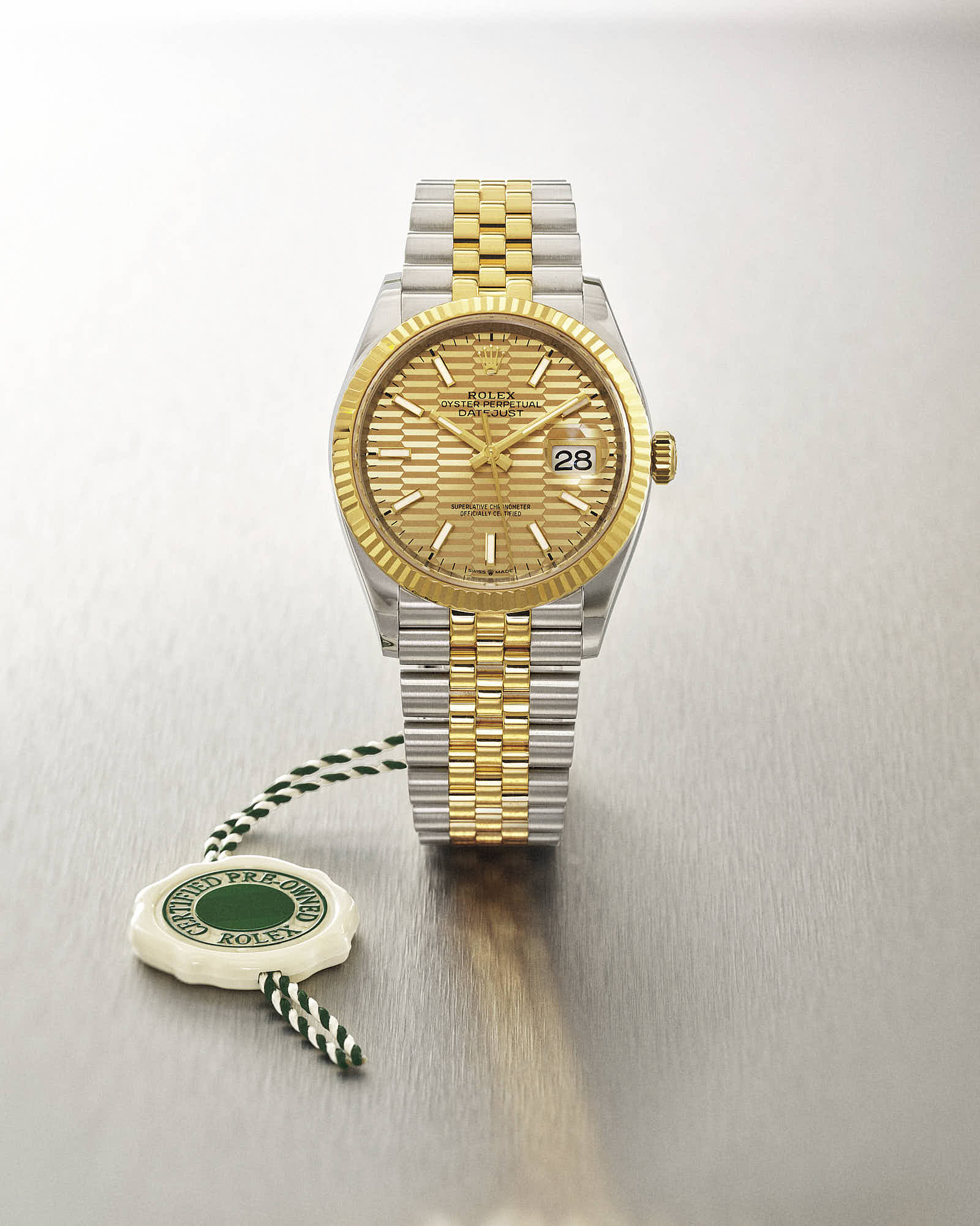 Luxury Rolex Datejust watch, two-tone gold and silver, with certified pre-owned tag.