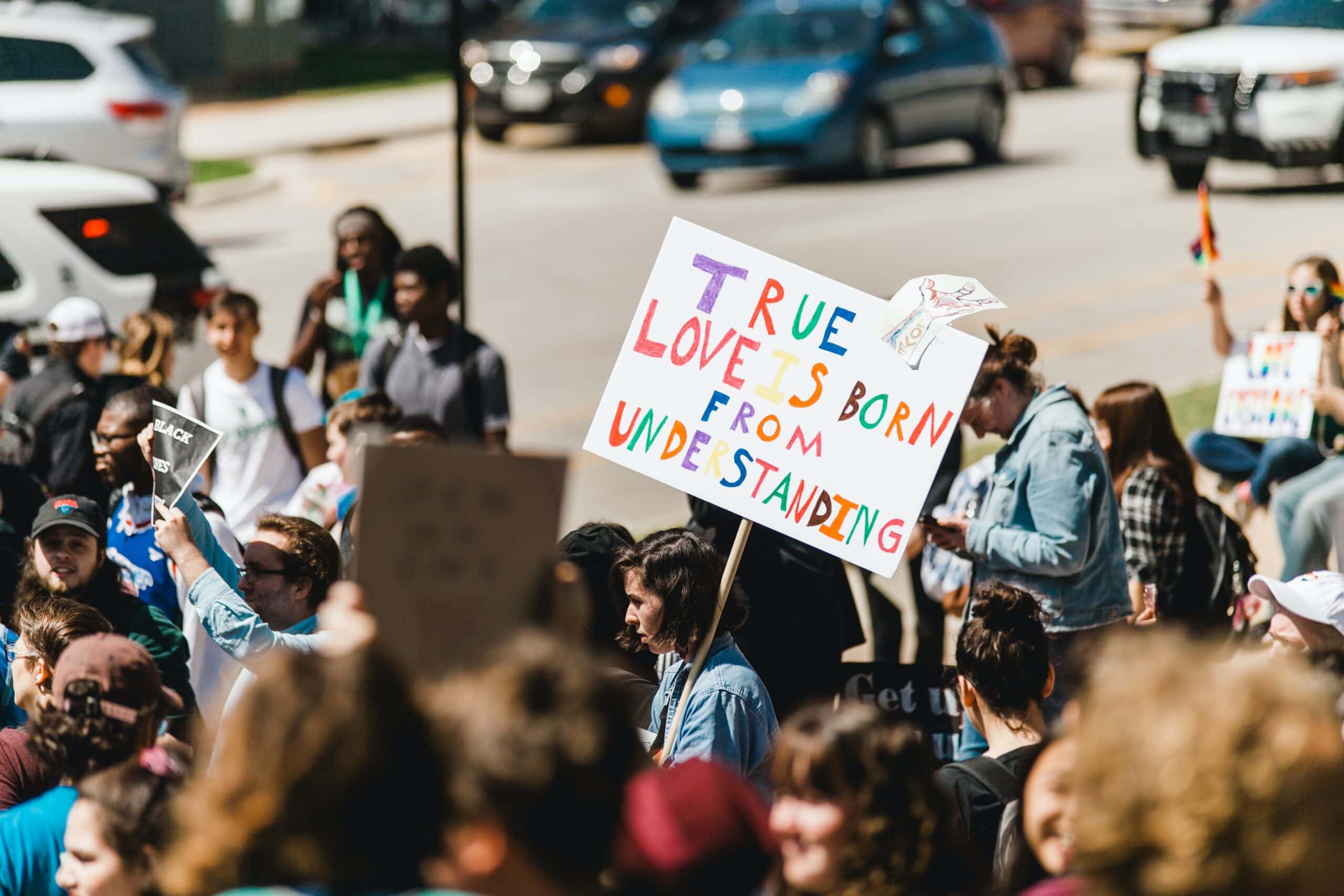 A pride protest, holding signs reading 