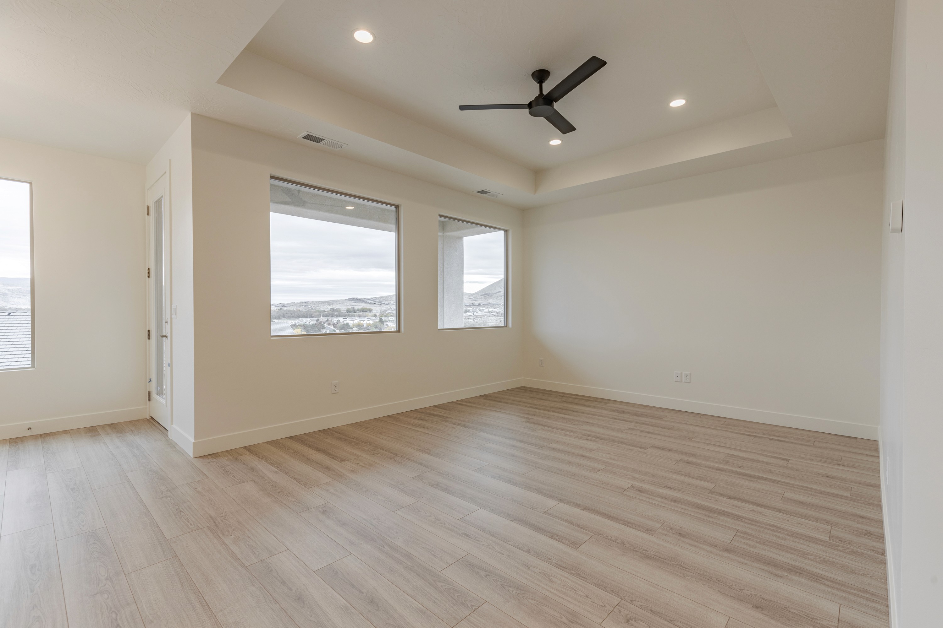 Great room in the Painted Sands twin home in Hurricane, Utah featuring open layout and natural light connecting to other living spaces.