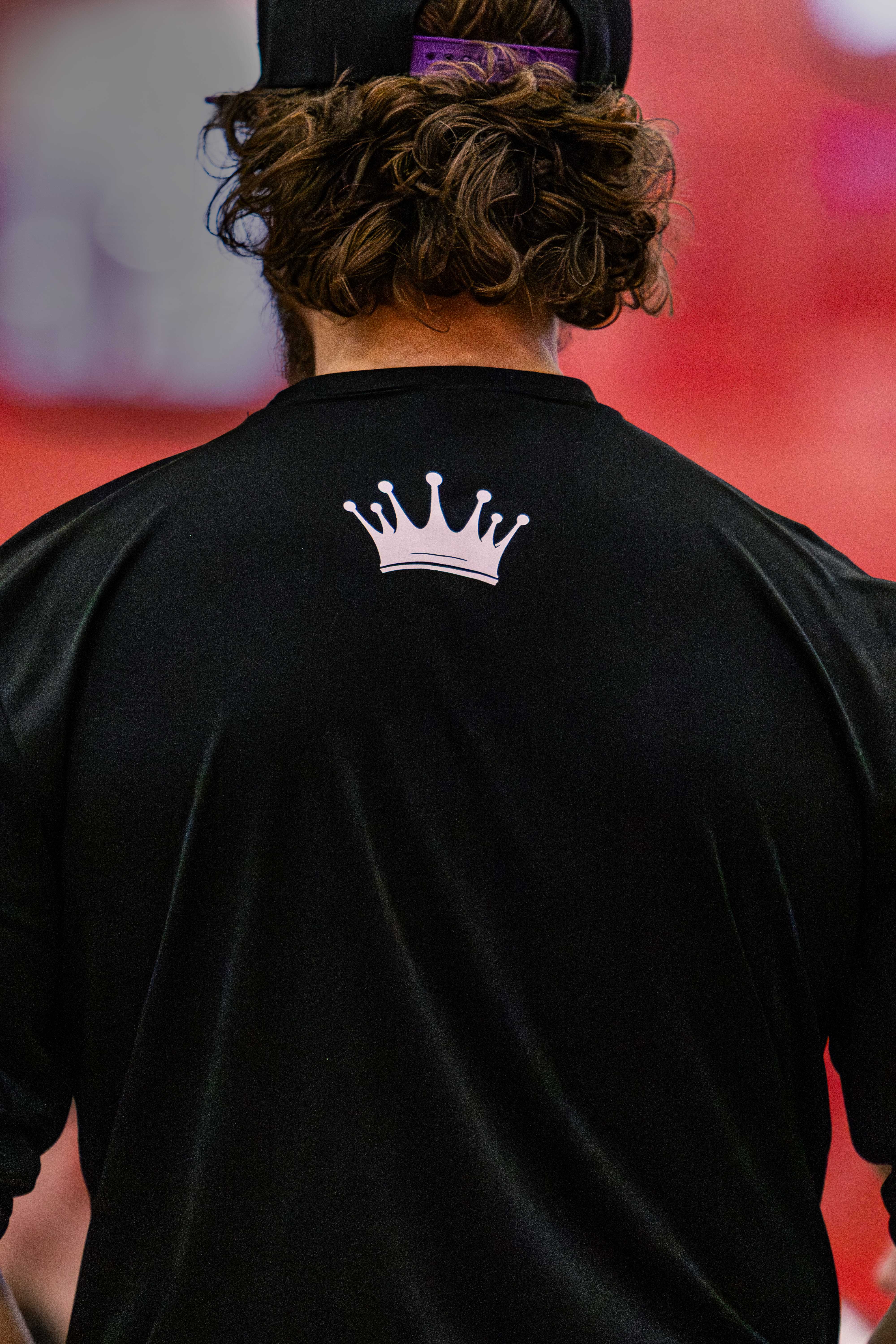 Rachel, personal trainer, looking to the side confidently in a fitness studio