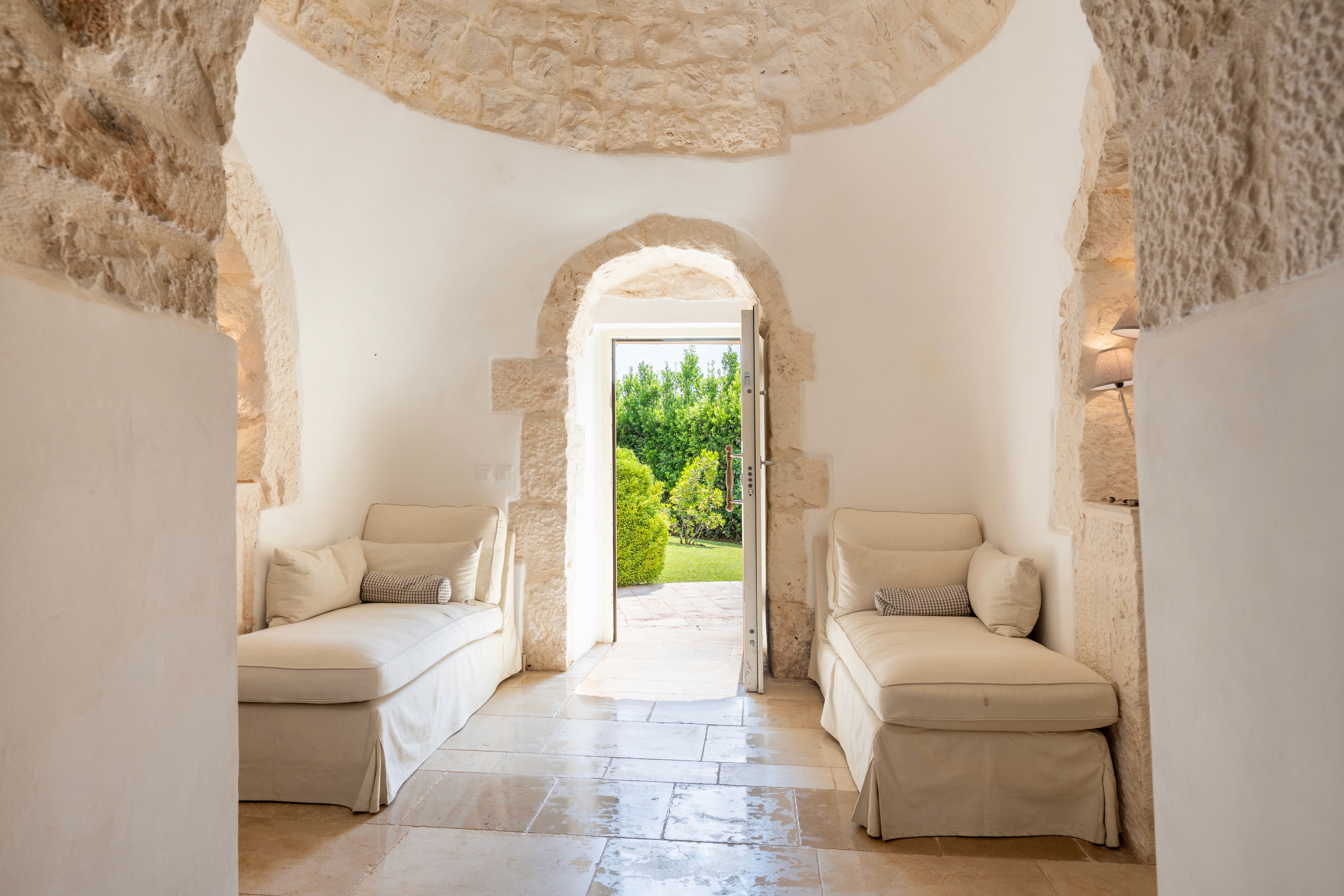 House with solar panels surrounded by forested hills