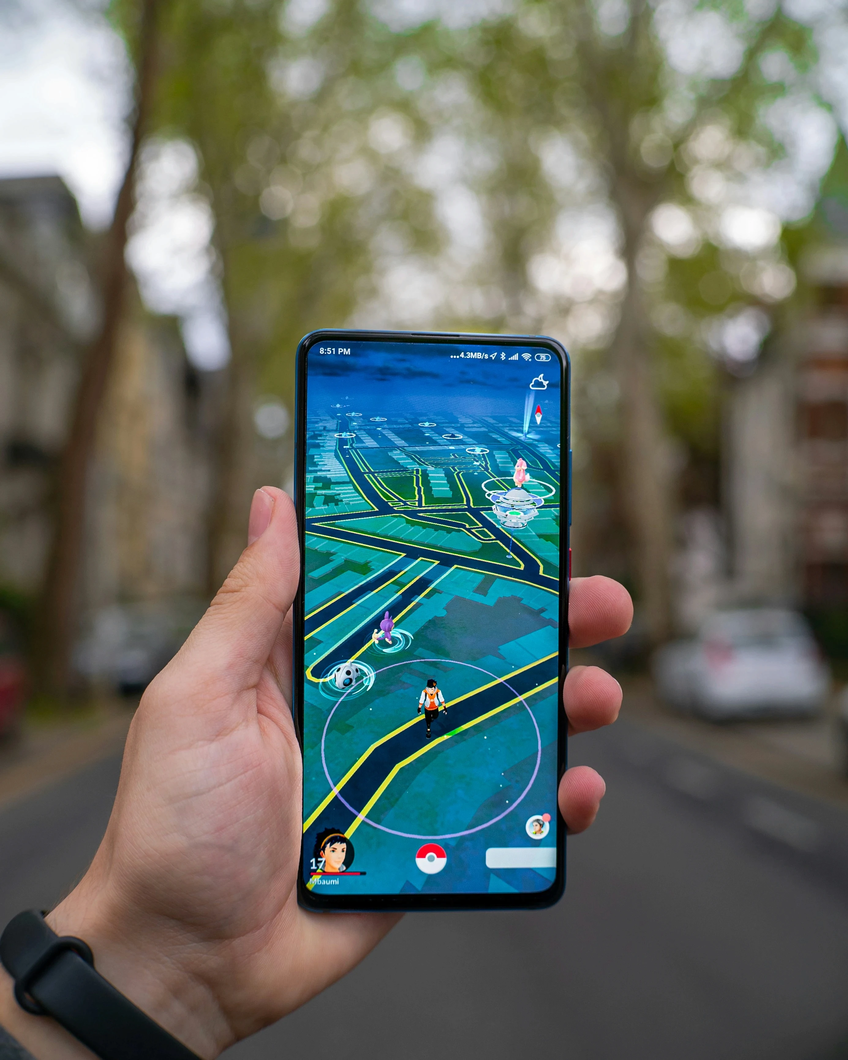 This image showcases a person holding a smartphone running Pokémon Go, one of the most popular examples of Augmented Reality app development. The app’s interface blends real-world environments with virtual game elements, highlighting the interactive and immersive experiences made possible by AR app development. The character and Pokémon displayed on the phone screen demonstrate the use of AR software to overlay digital creatures onto physical locations, offering users an engaging and interactive experience. The image exemplifies the role of Augmented Reality app developers in creating apps that allow users to explore the world around them while interacting with digital content in real-time. The streets and background blur in the image, keeping the focus on the app’s interface, which represents the sophisticated design of Augmented Reality software development used to enhance user engagement. This visual captures the essence of how AR app development has transformed gaming by merging the digital and physical worlds, providing users with a dynamic, location-based adventure."  This alt tag effectively integrates the main keyword "Augmented Reality app Development" and LSI keywords, while describing the image content in detail.