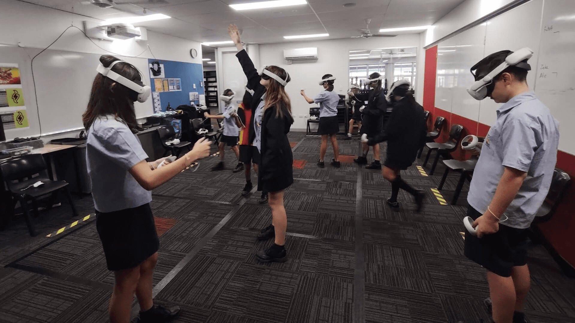 Students in a classroom using VR/MR headsets for active experiential learning and physics experiments.