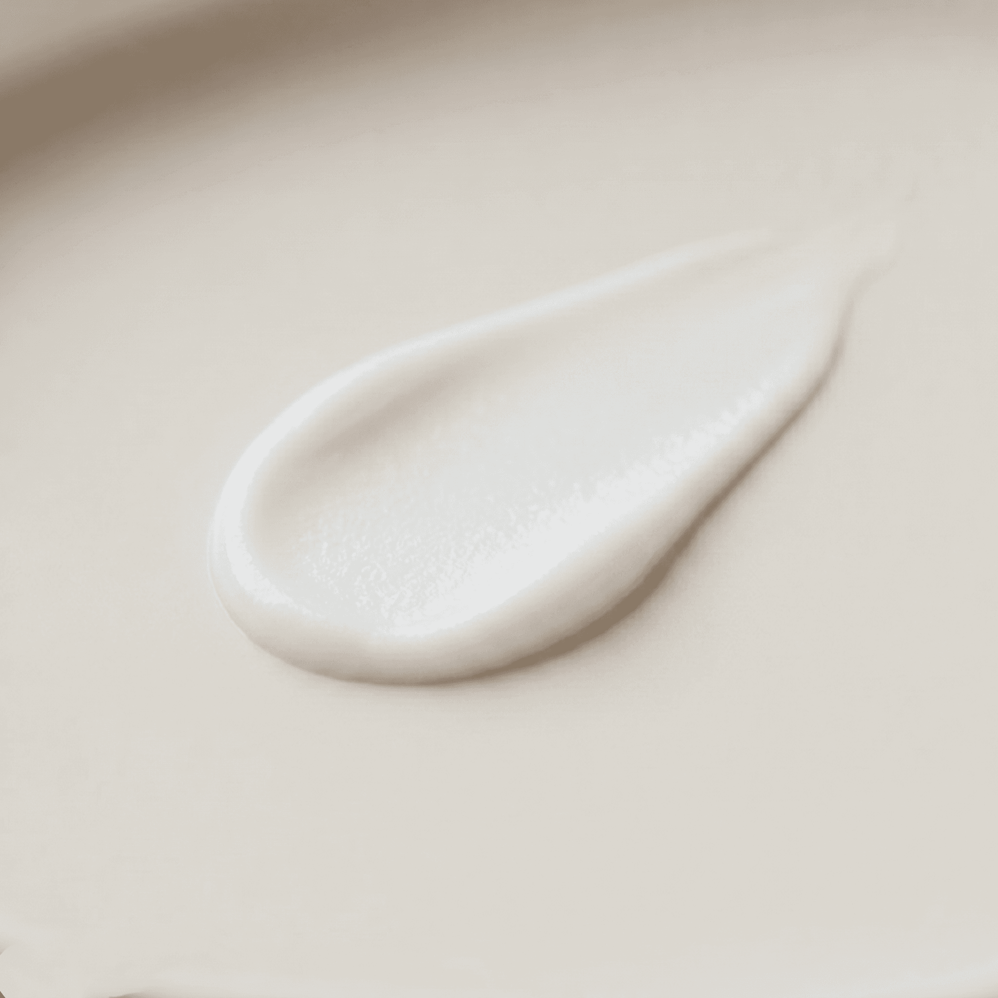 Smooth smear of balm for dogs on a neutral surface, showing even spread, controlled texture, and a low-gloss finish