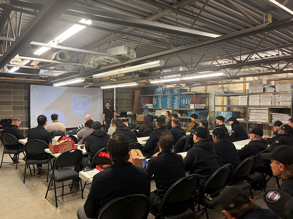 Two EDL staff members taking a selfie at a sports event.