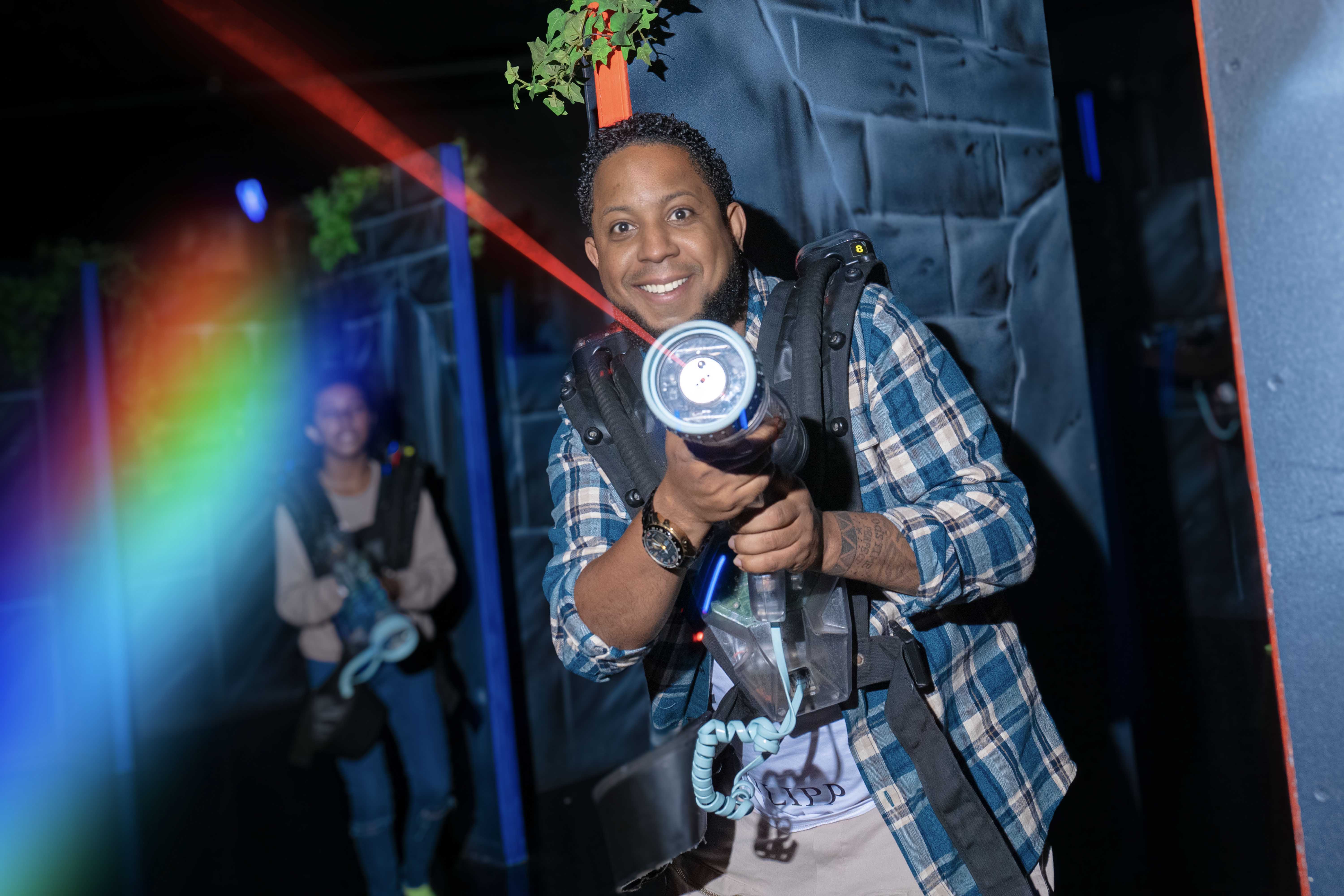 older man shooting lasr gun at Flip Out Adventure Park