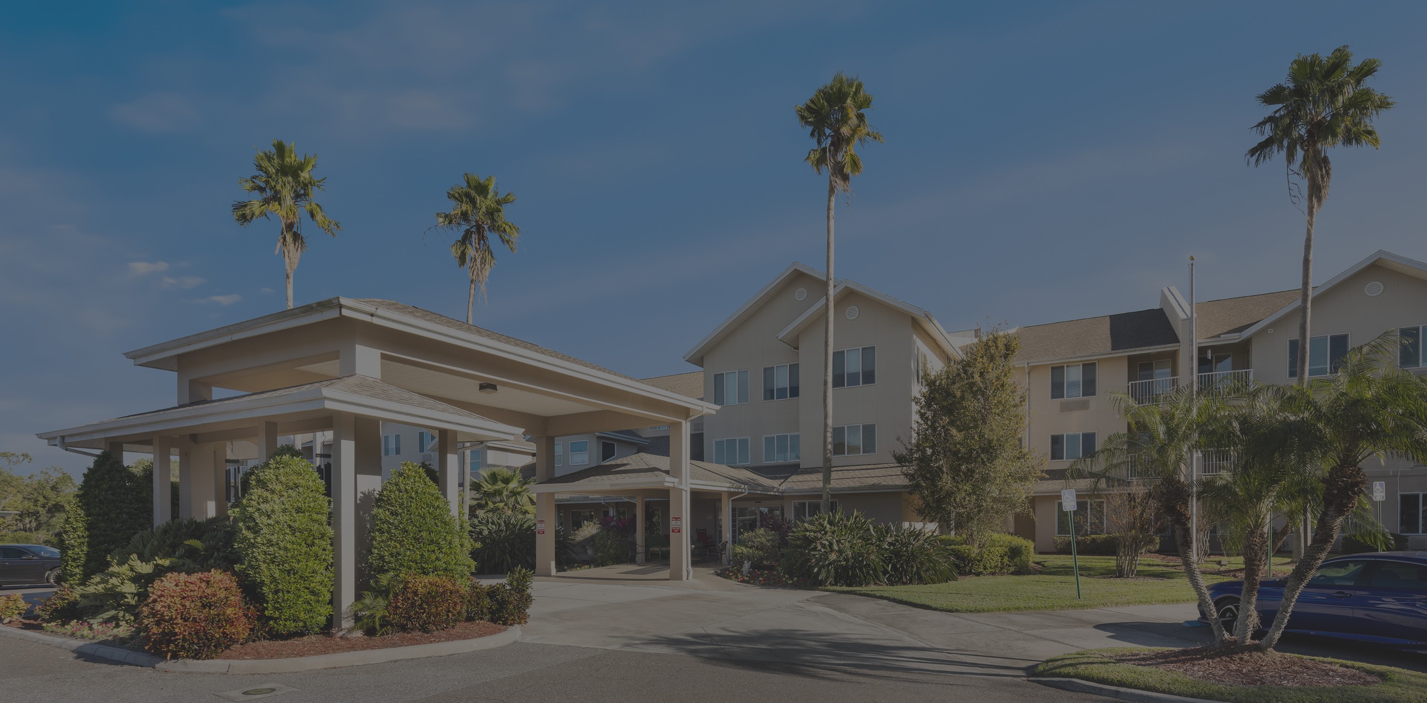 Black and white background image of the Universal glob statue nessled amidst tropical flora