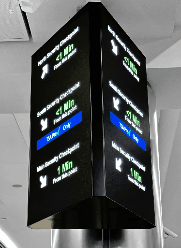 A photo of two smart signs showing security checkpoint wait times