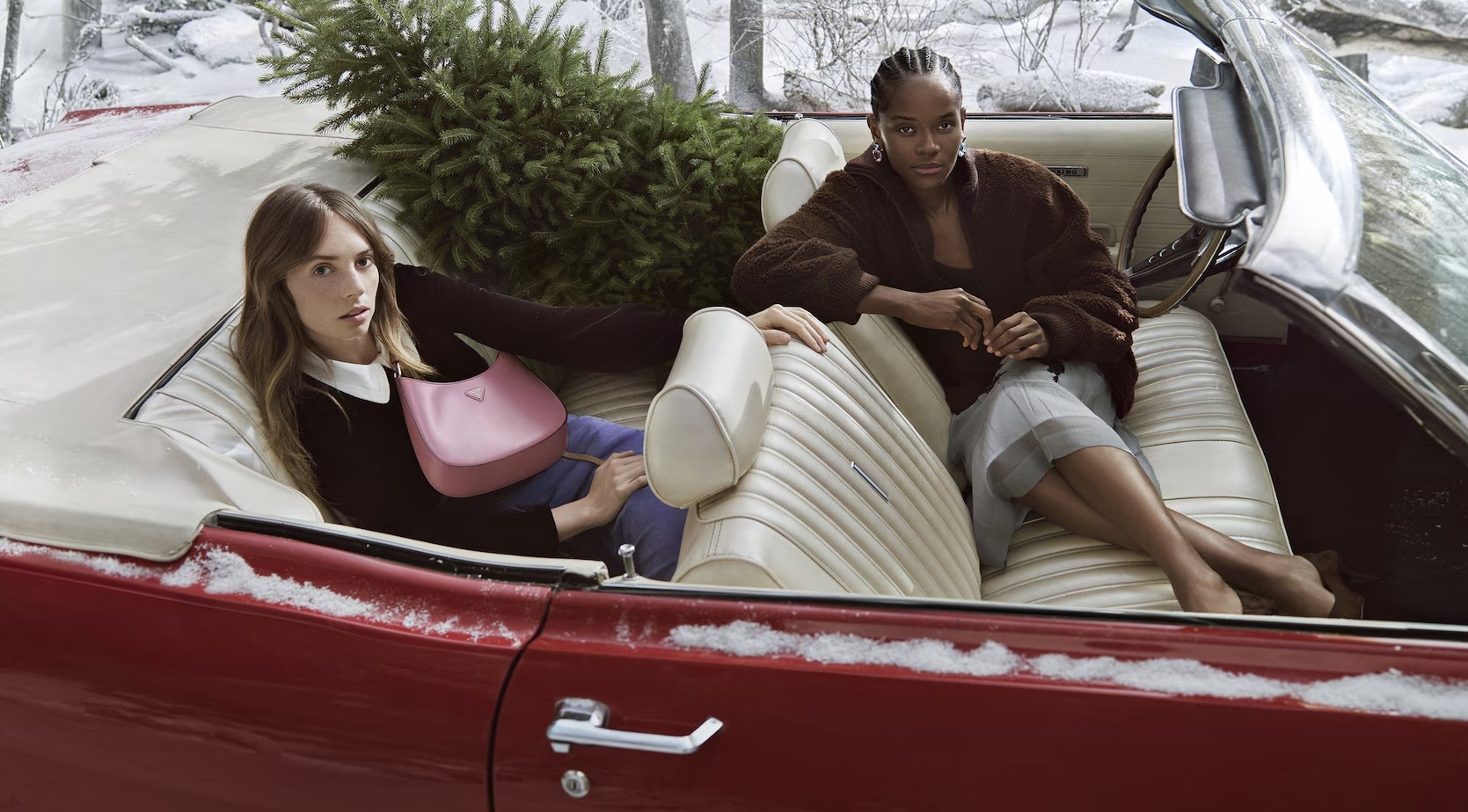 Stylish woman in a gray athletic outfit and headband standing confidently in a stadium, surrounded by empty blue seats and overhead steel beams.