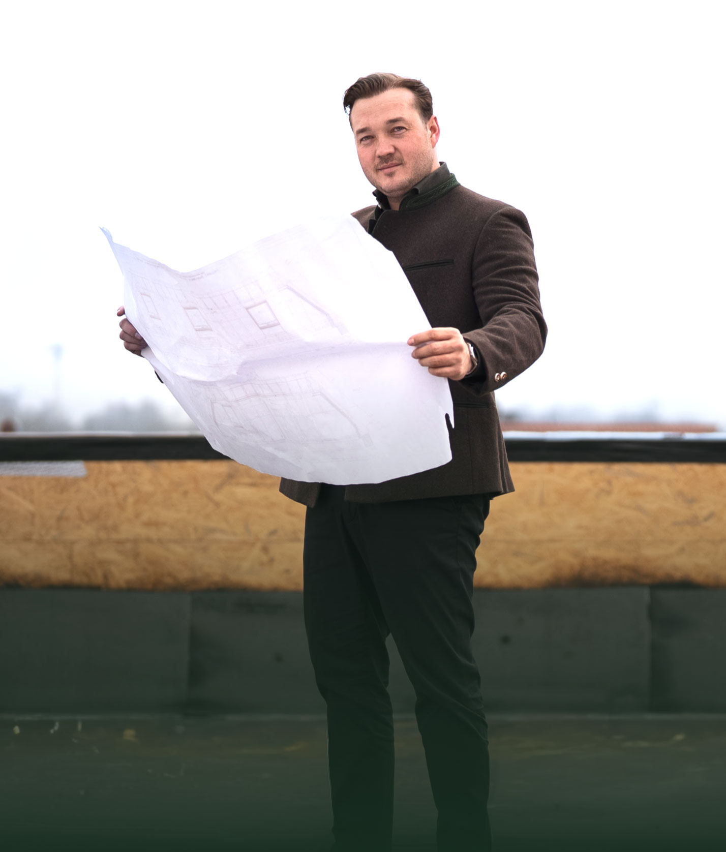 Spacious, luxurious living room with high ceilings, an elegant beige sectional sofa, warm ambient lighting, classical artwork, and rustic architectural elements, featuring an open layout with a view of a mezzanine level.