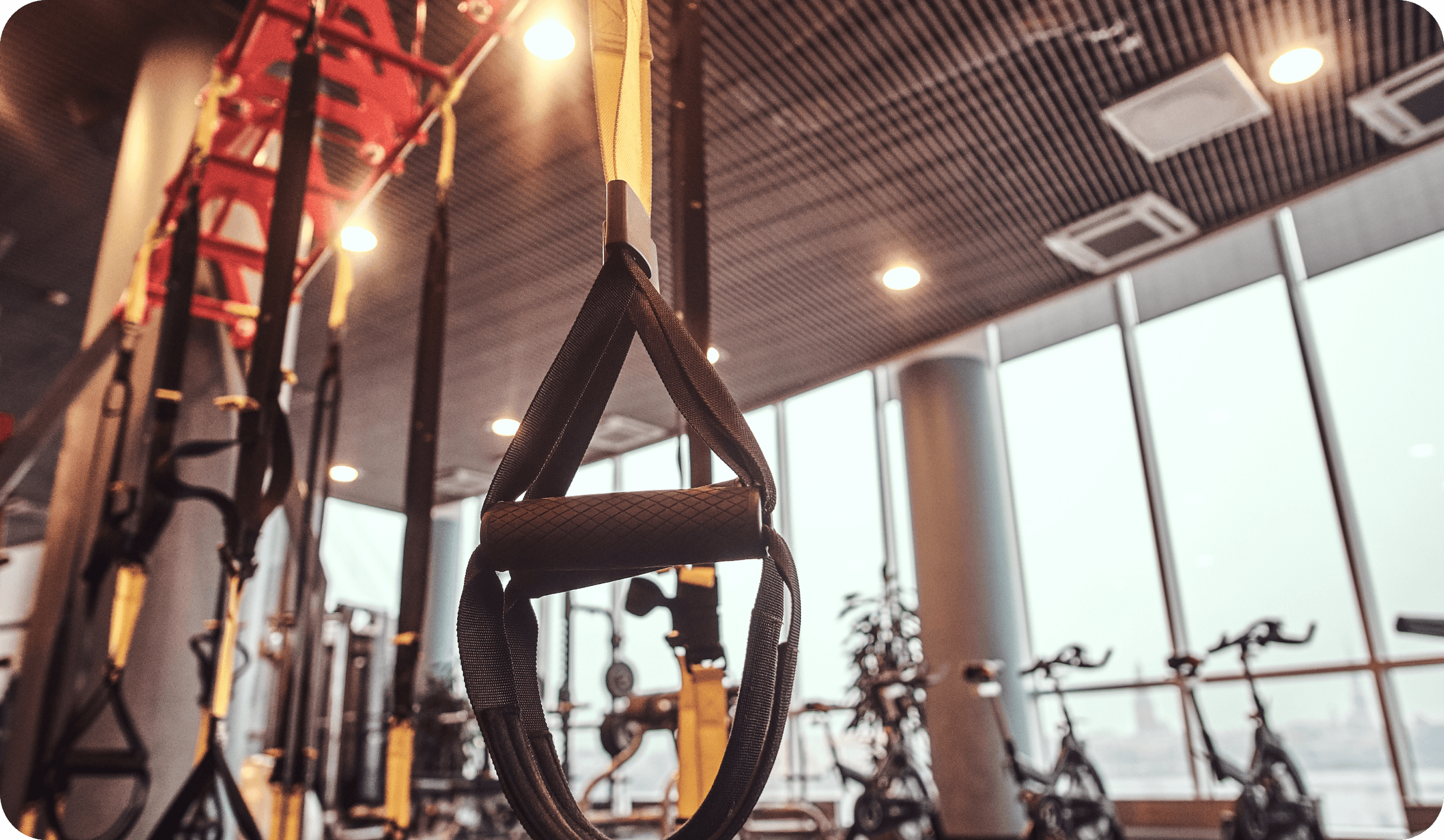Close-up of a suspension trainer handle in a gym.