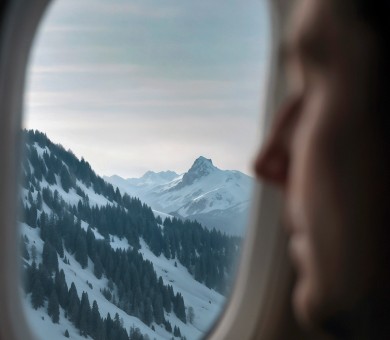View of snowy mountains from an airplane window