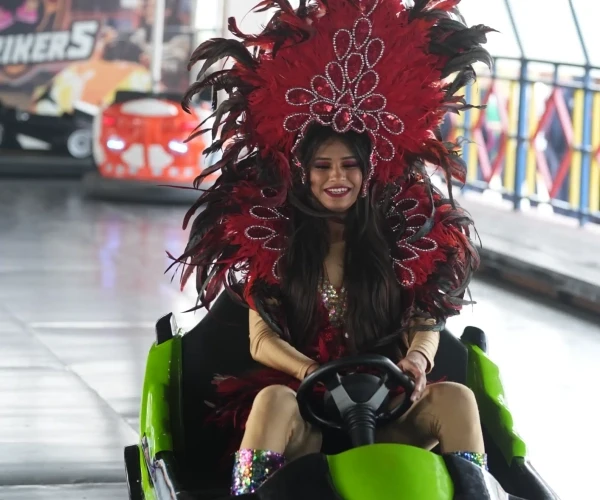Sunlit modern living room with orange chair, plant.