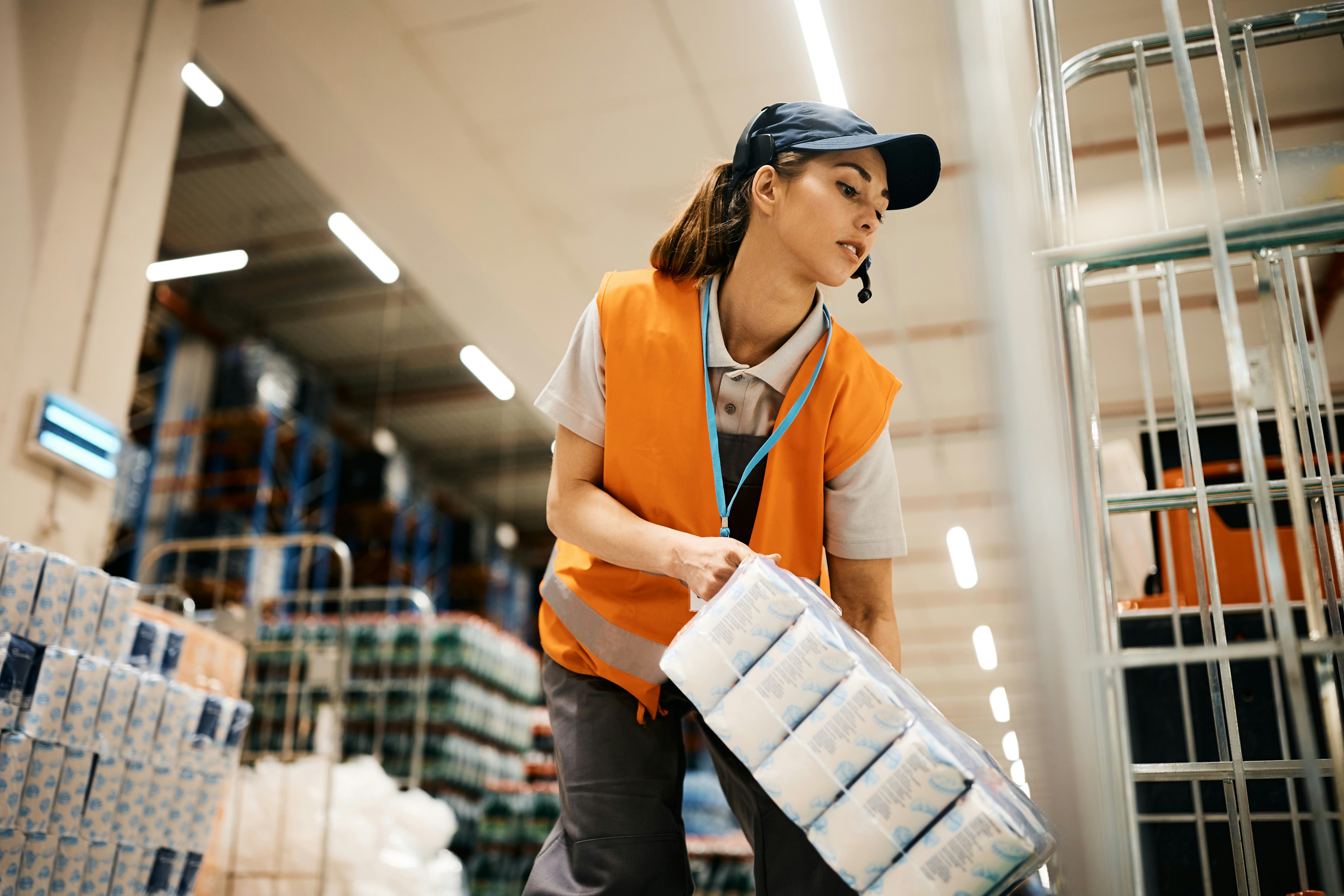 female warehouse worker stacking items