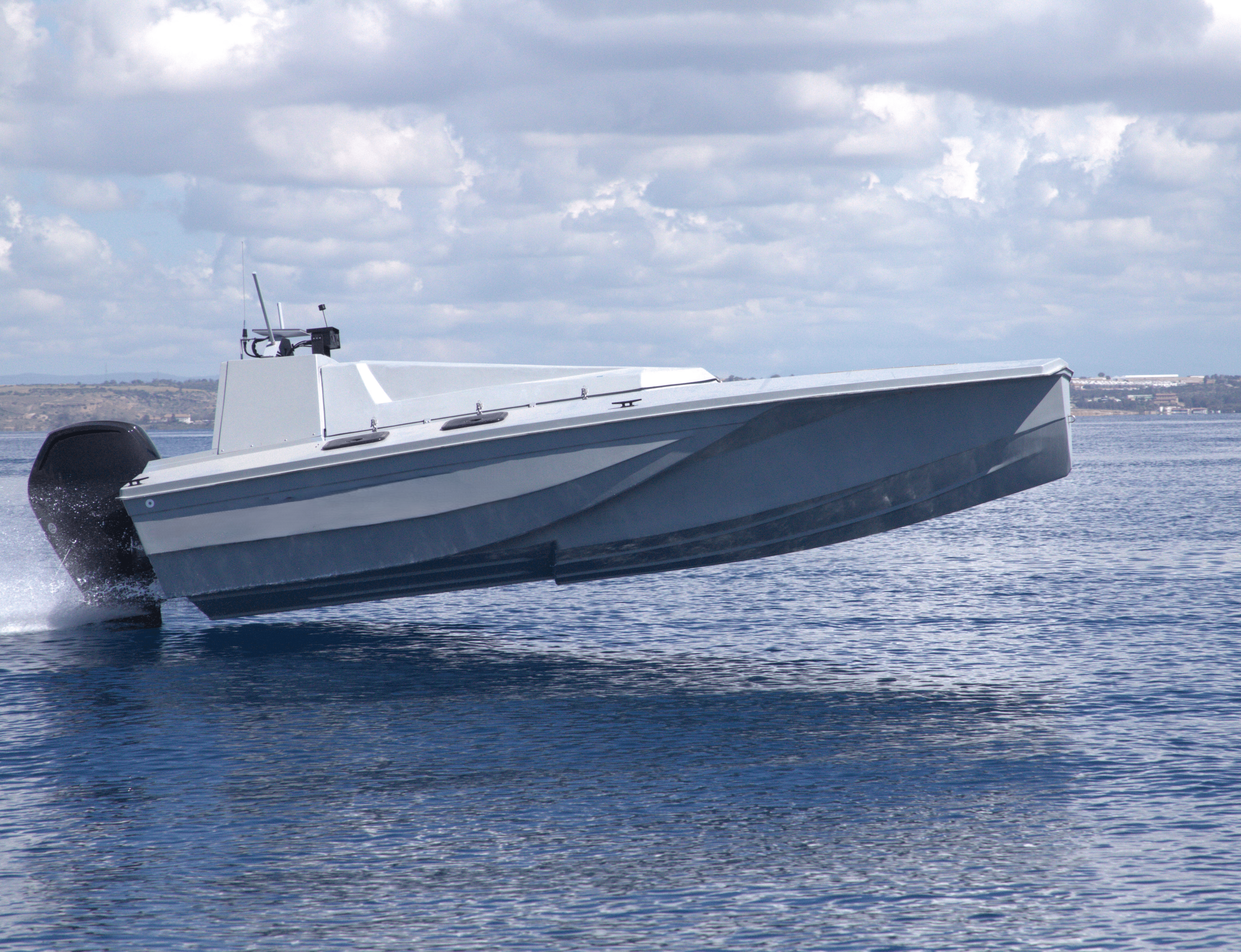White passenger boat moving across bright blue water