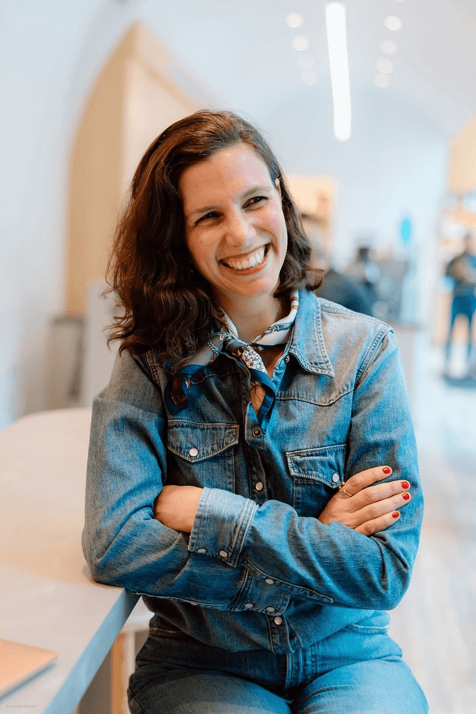Chloe wearing a denim jacket and smiling