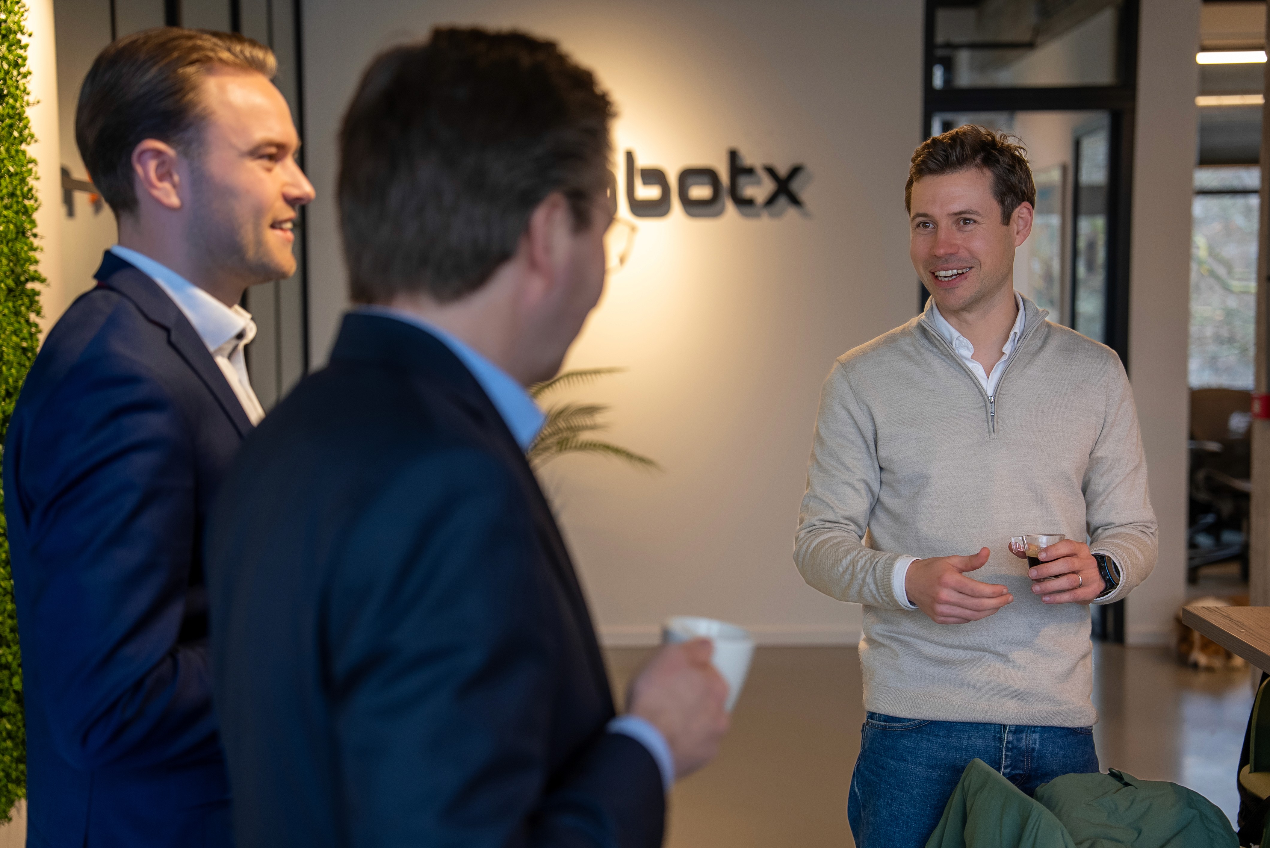 Robert Hyde, founder of RobotX, speaking with BDO partners Leon Jansen and Joost Lepoutre at the RobotX office